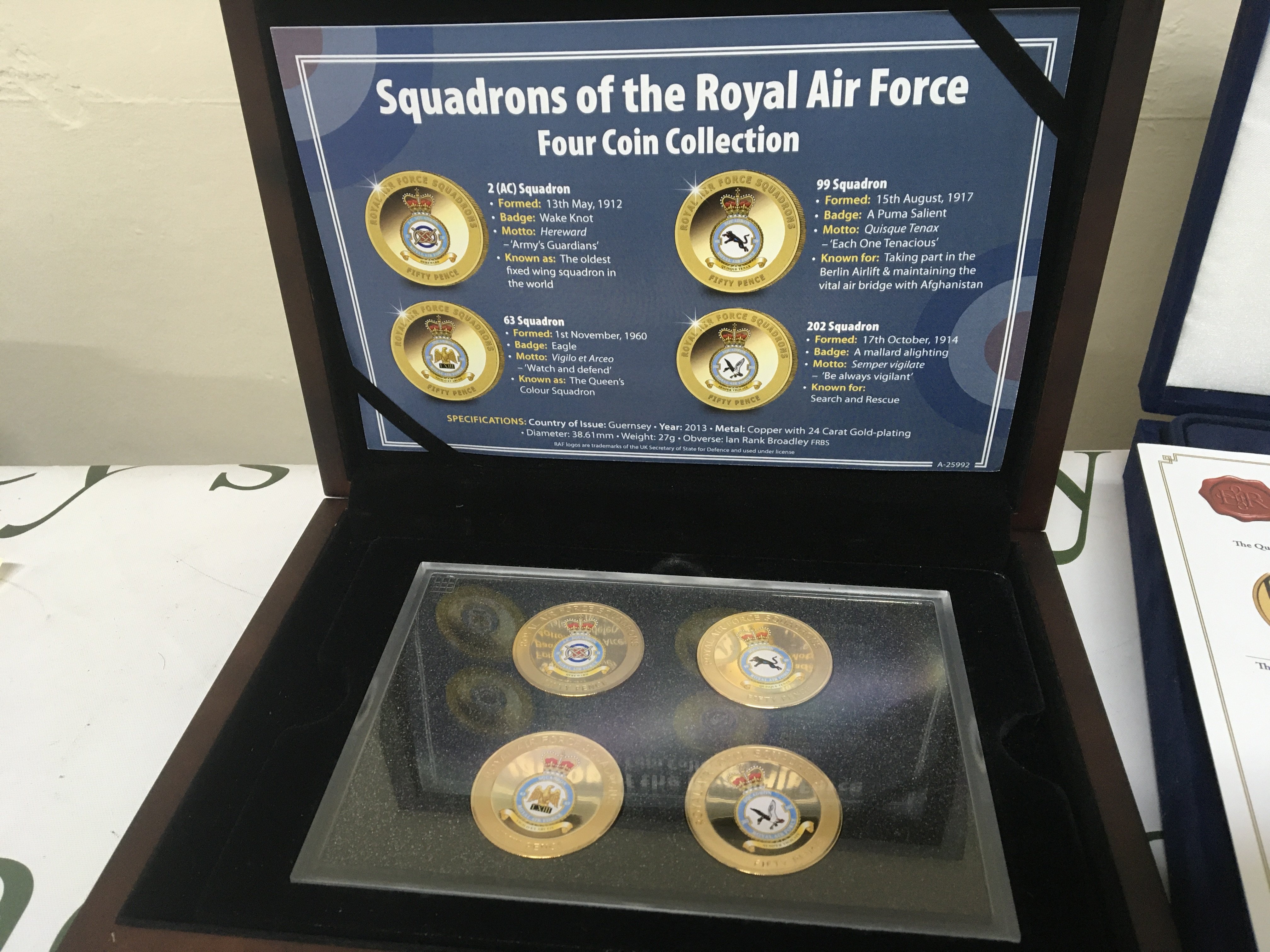Four cases containing coin collections US presidential dollar Collection Squadron of the Royal Air Force 2008 Royal Shield Proof coins and Diamond Jubilee coin set (4)