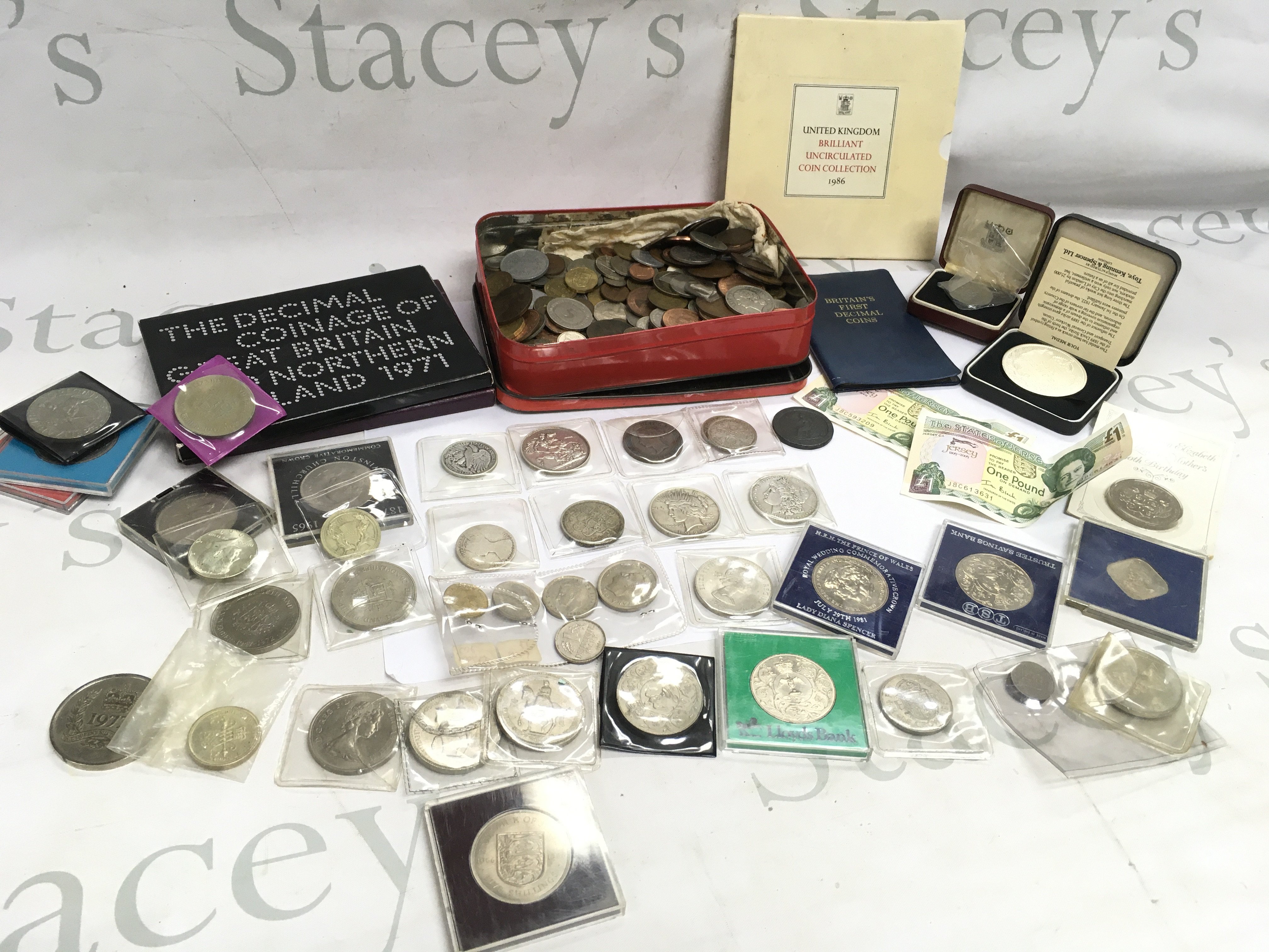 A mixed collection of world coinage including a 1922 US liberty dollar ,1881 US Dollar, 1887 crown, 1797 George III penny etc. 1986 Brilliant uncirculated coin collection, The Decimal coinage of GB and Northern Ireland 1971 etc. postage category B
