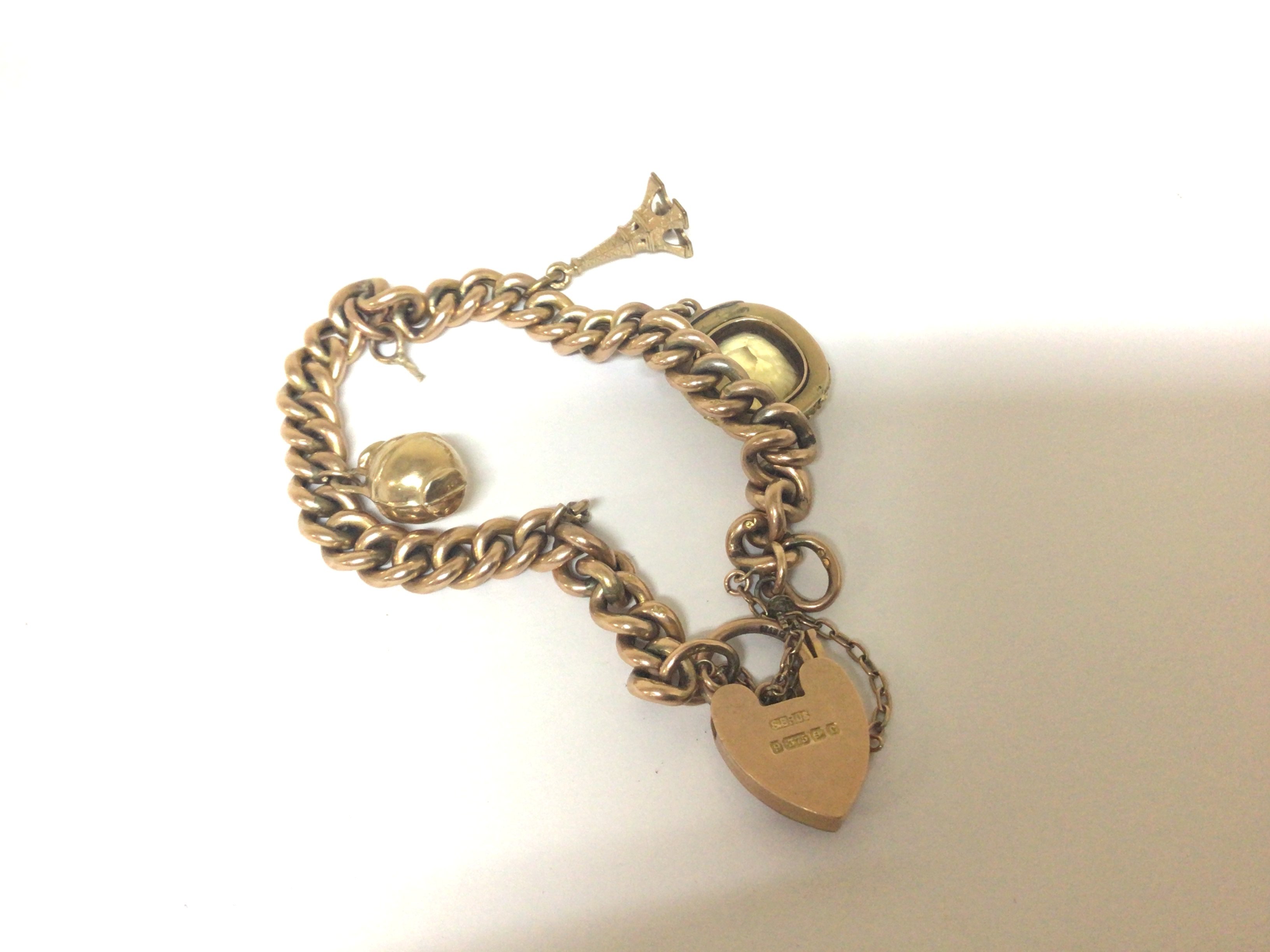 A 9carat gold Charm bracelet one charm unmarked set with a cut Citroen stone total weight 19g