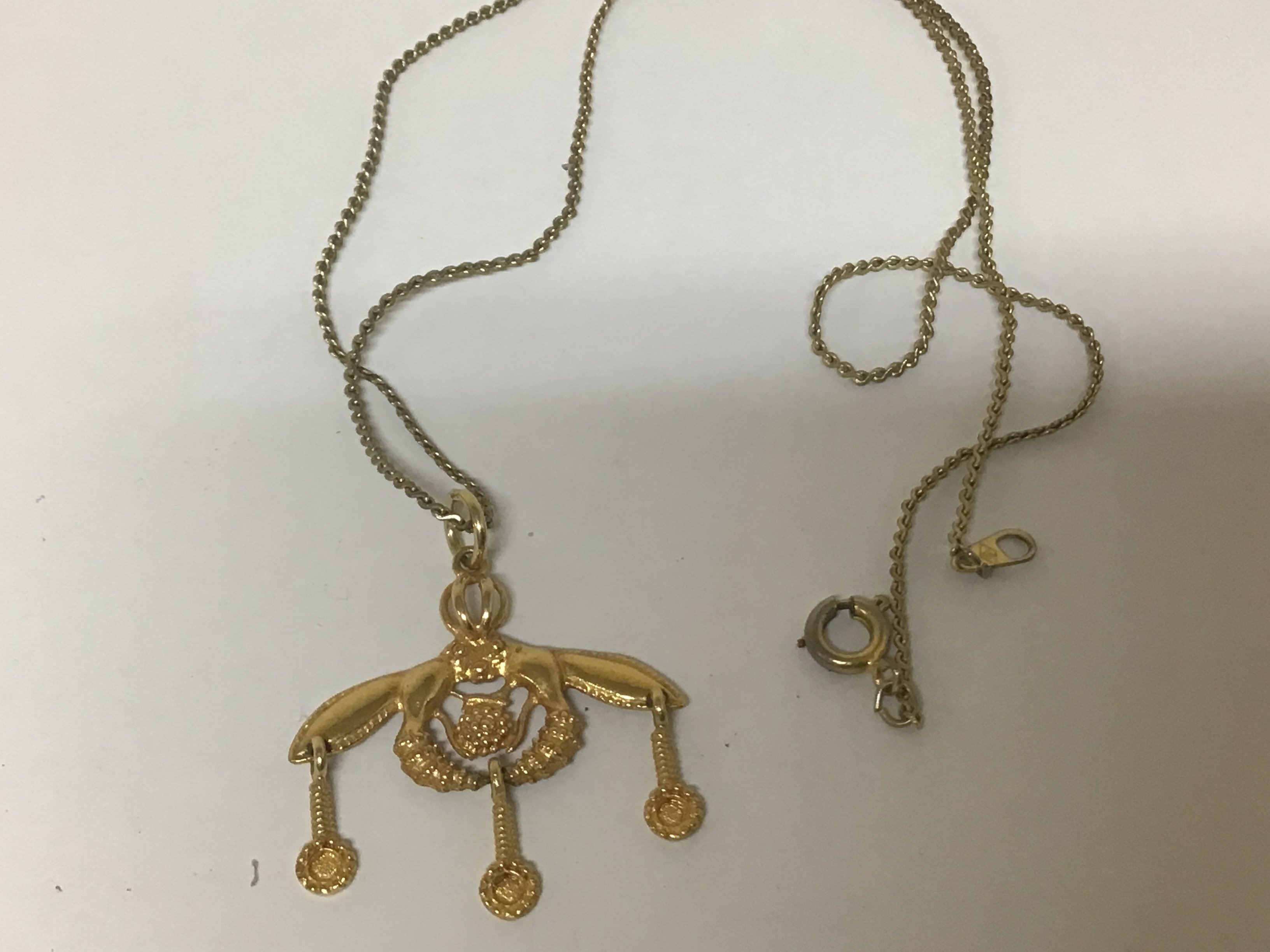 A 14carat gold pendent with three small drops weight 2g with a gold plated chain.