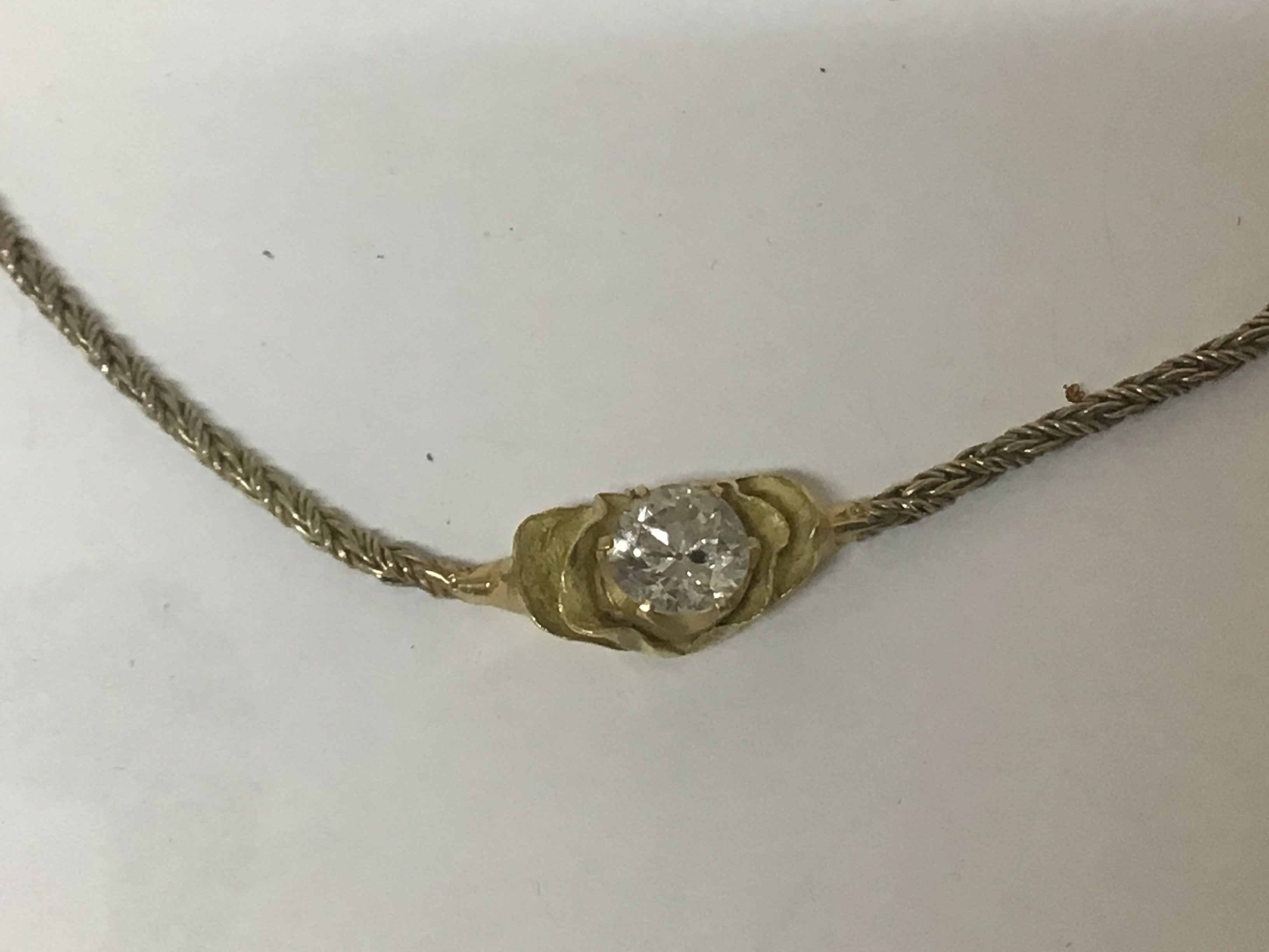 WITHDRAWN - An 18carat gold pendent set with a brilliant cut solitaire diamond with attached 9carat gold chain.