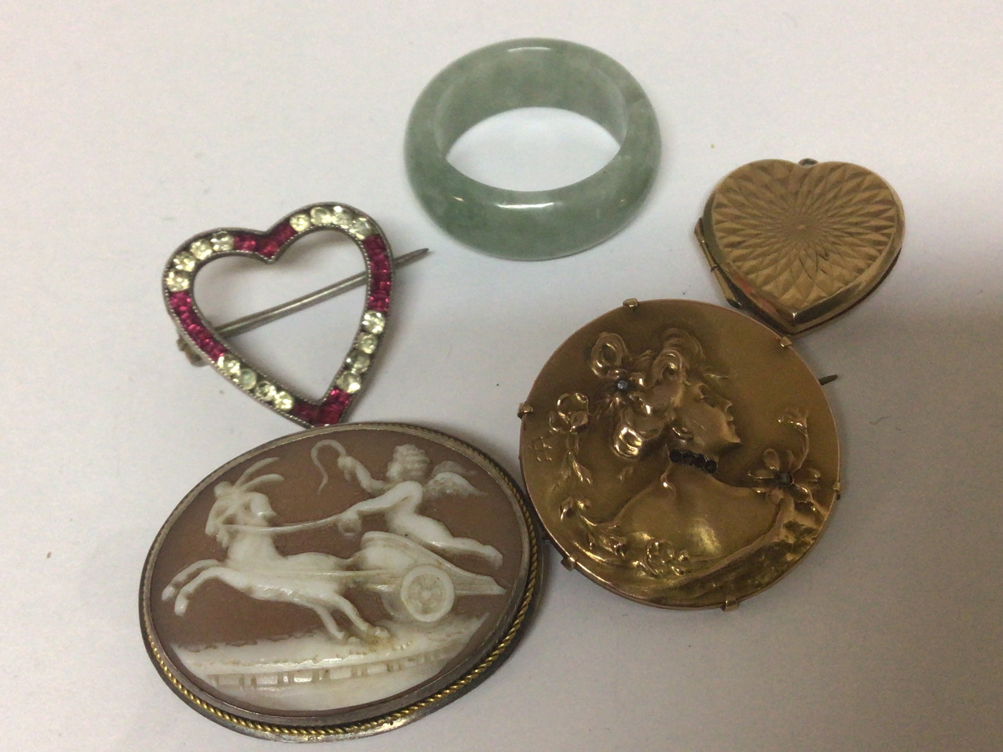 A Jade ring a Cameo brooch a 9carat gold locket and an unmarked art nouveau brooch.