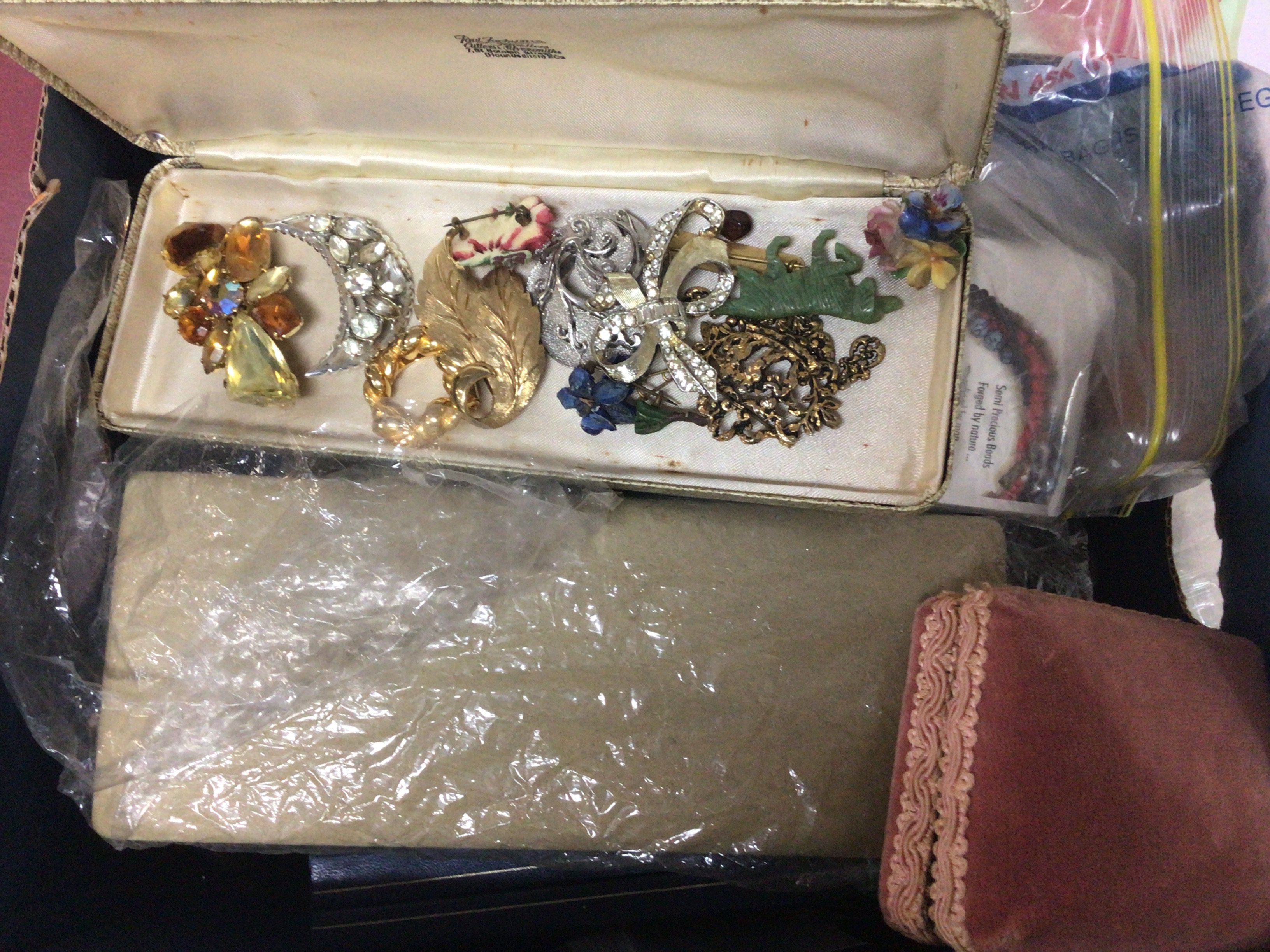 A box containing costume jewellery including some silver jewellery.