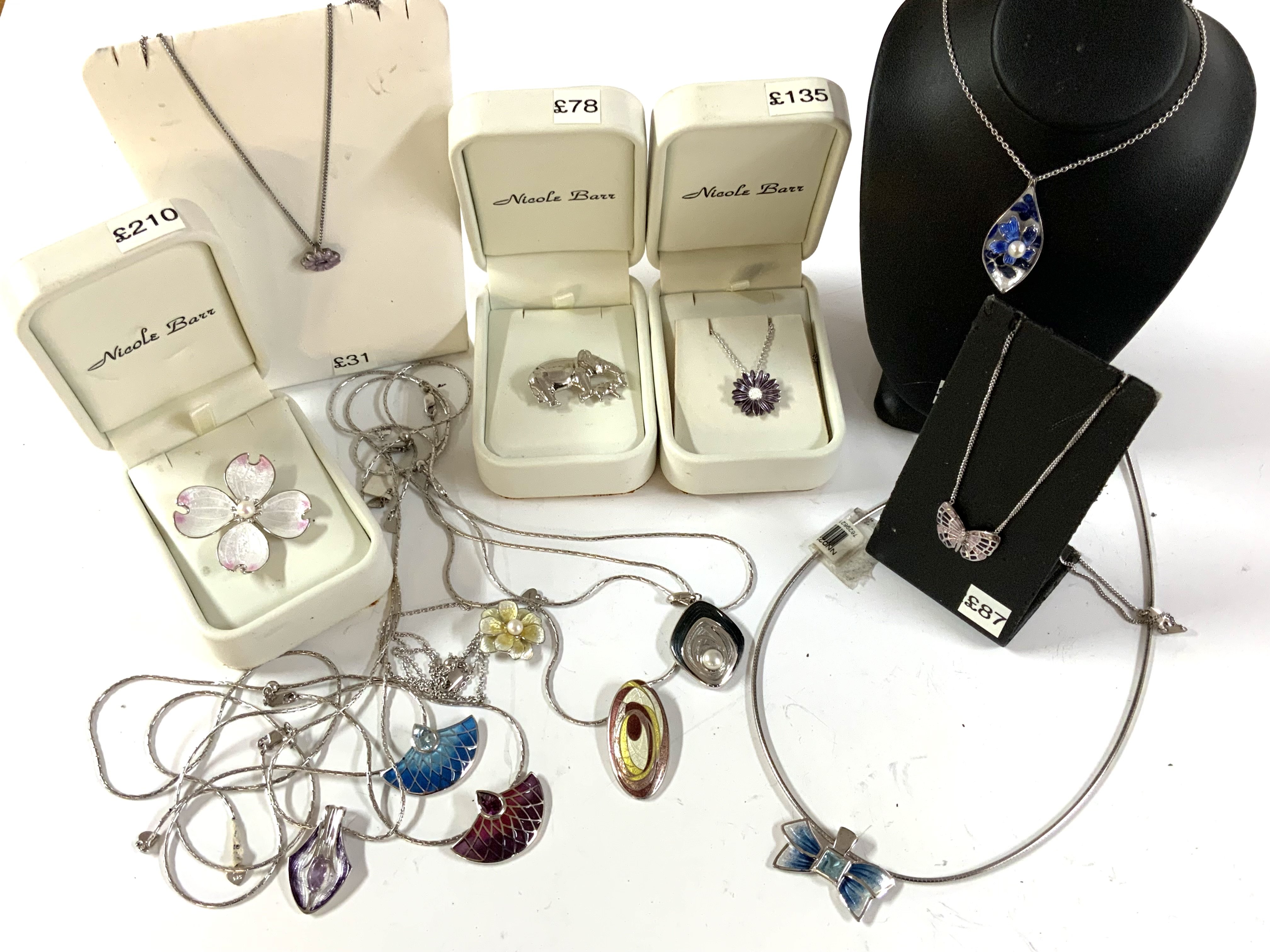 A mixed collection of silver and enamel jewellery.