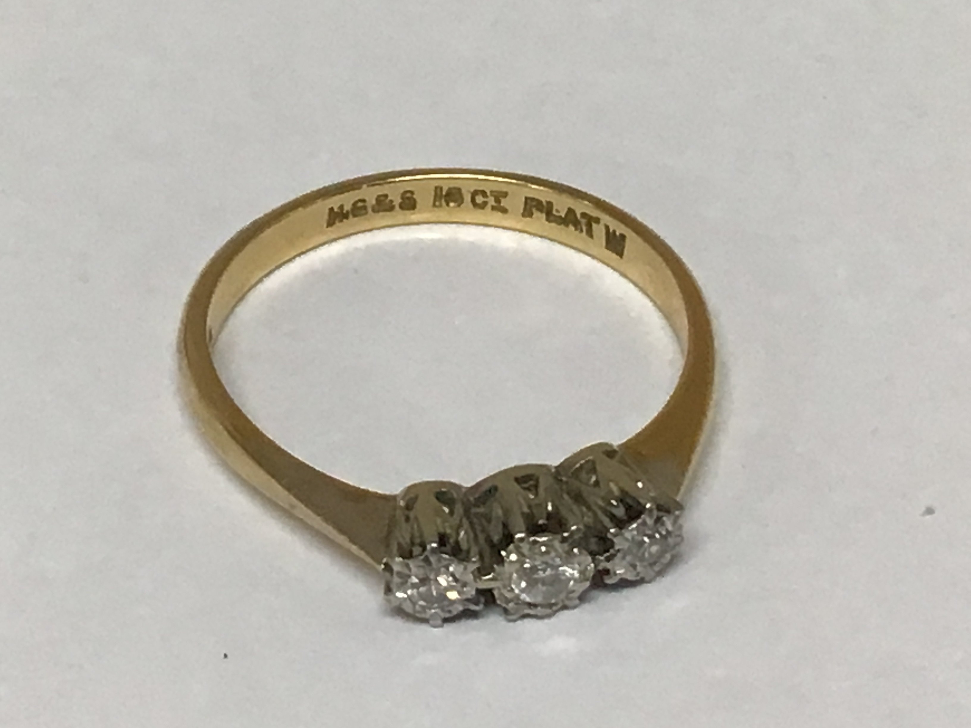 An 18carat gold ring set with three small diamonds ring size P weight 2.5g
