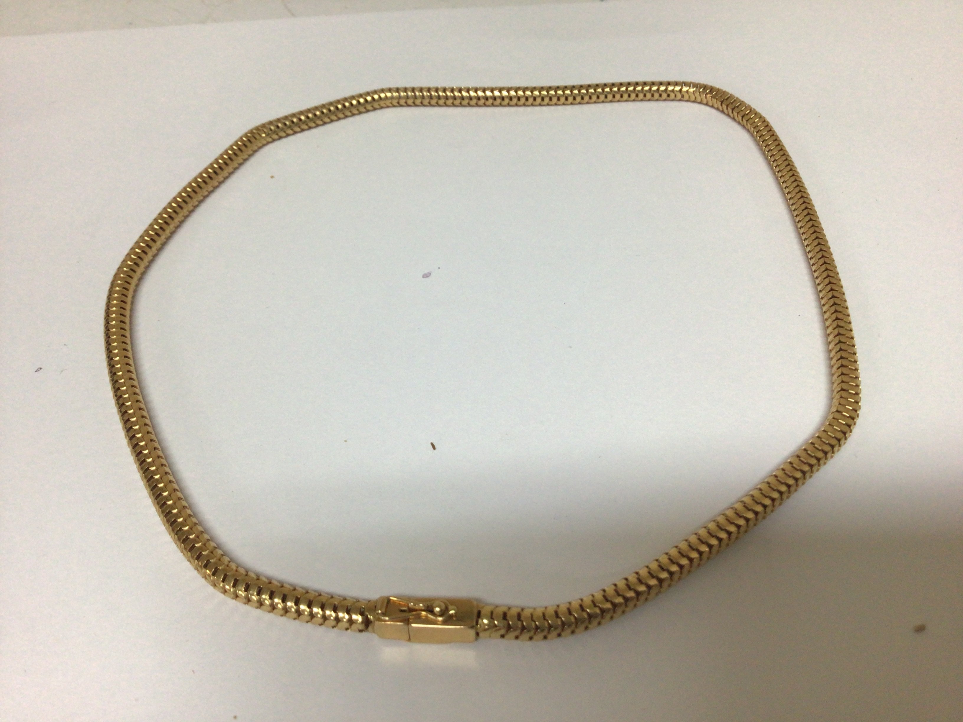 A modern 18carat gold necklace of circular form with a rectangular clasp weight 22g