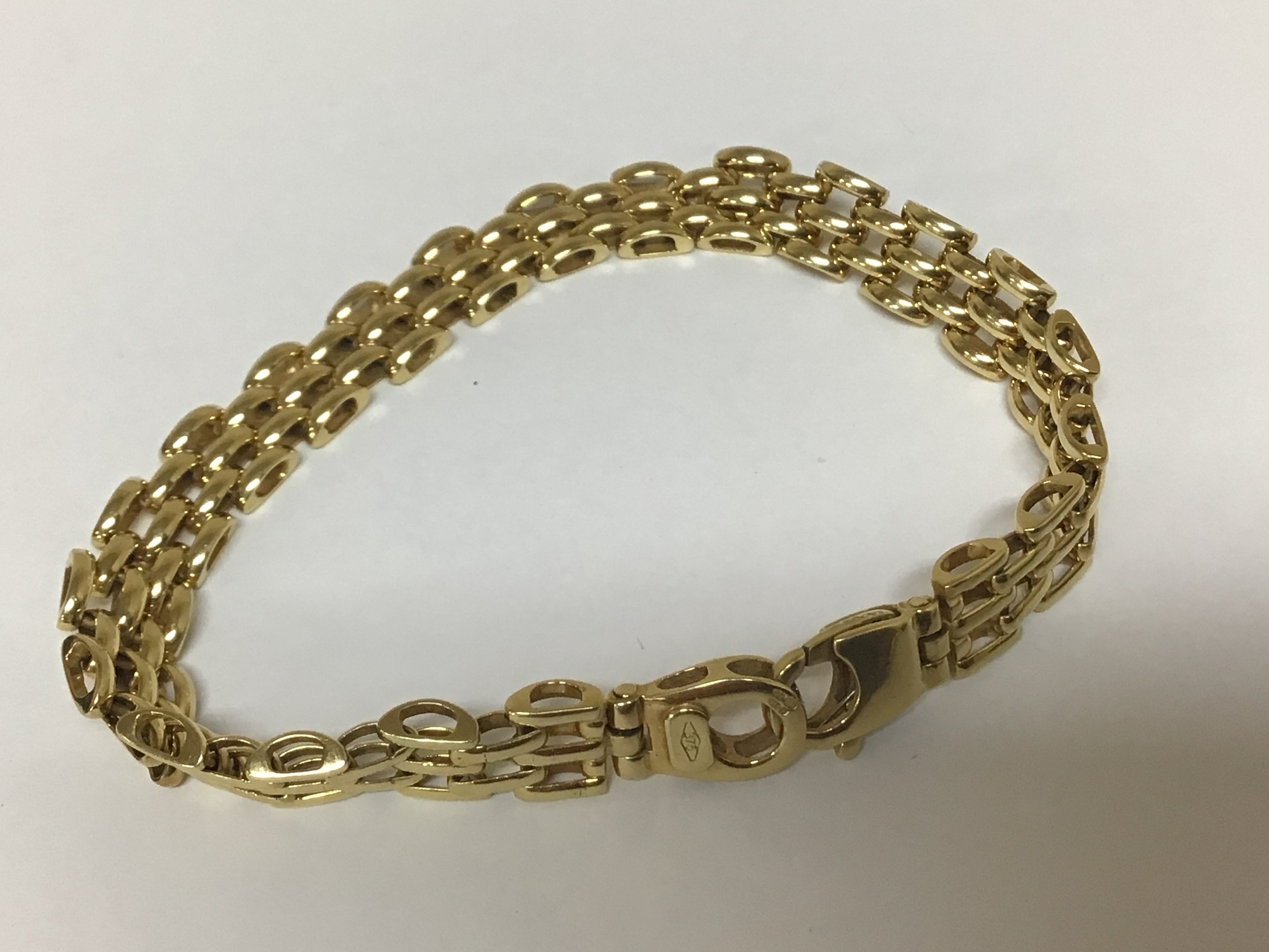 A Modern 9carat gold bracelet with rows of three repeating links. Weight 12.5g