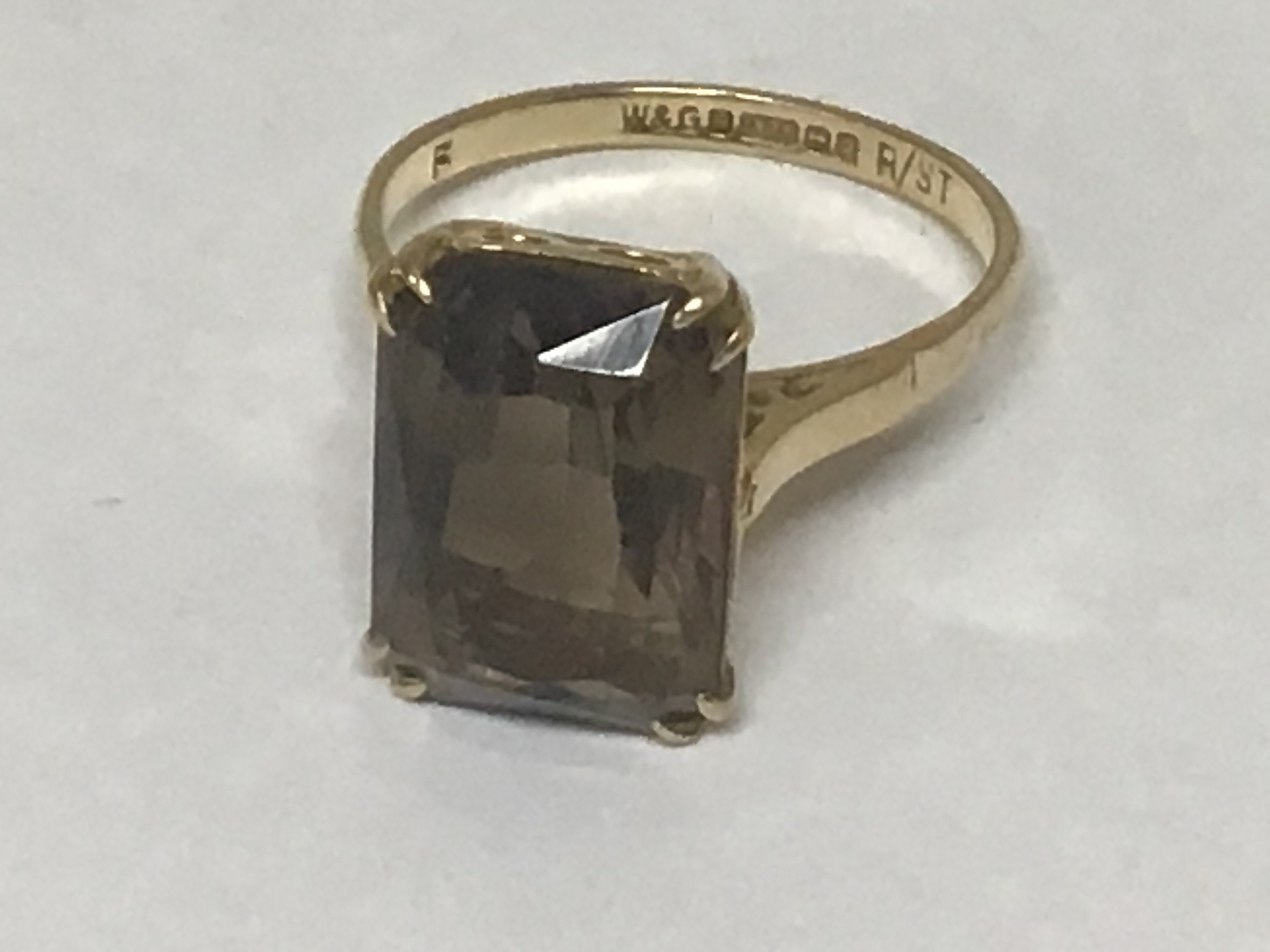 A 9carat gold ring set with a good sized smoked quartz of rectangular shape.