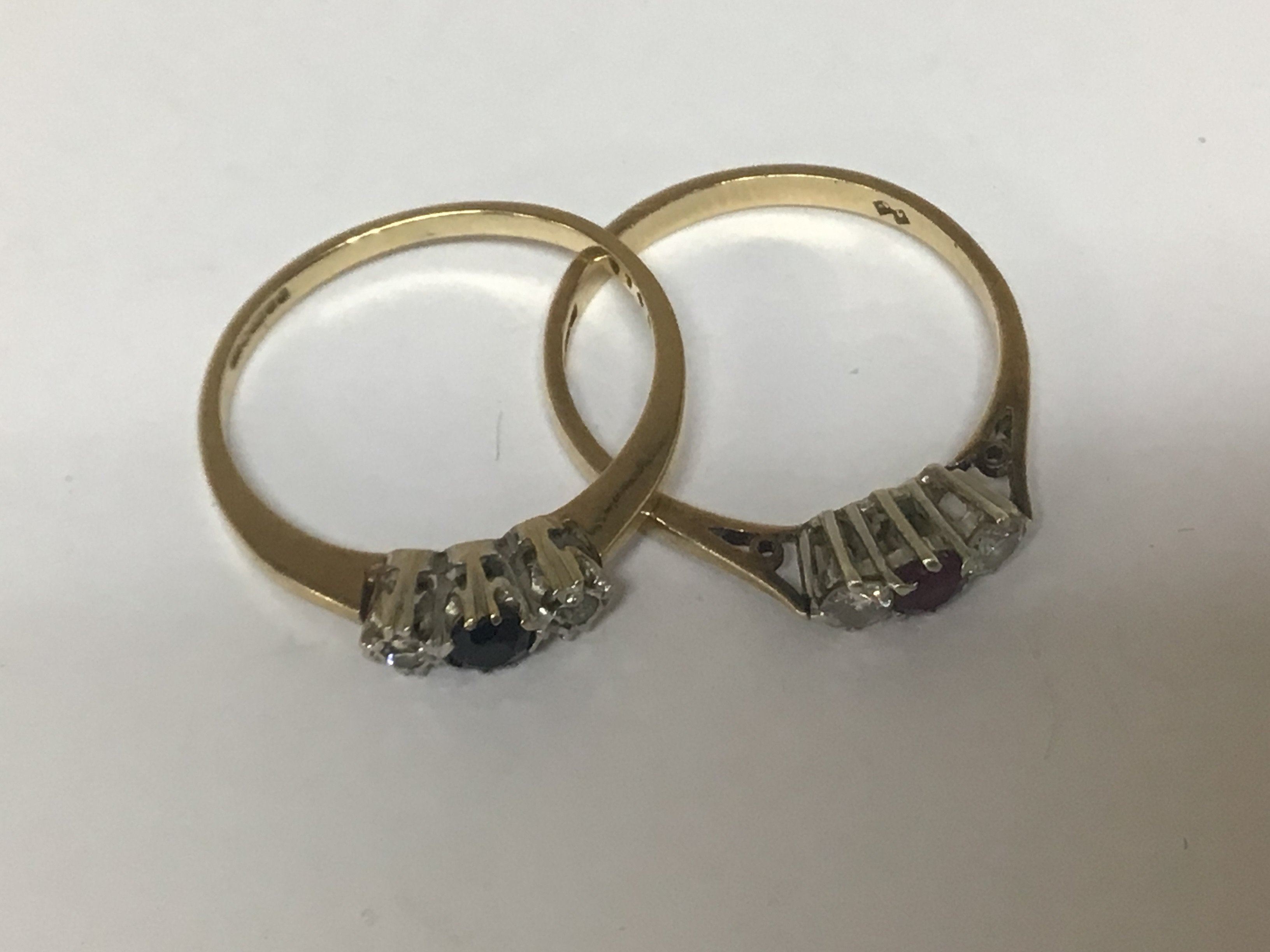 Two 9carat gold rings of conforming design set with ruby and sapphire each flanked by diamonds weight 3.2g ring size N-P (2)