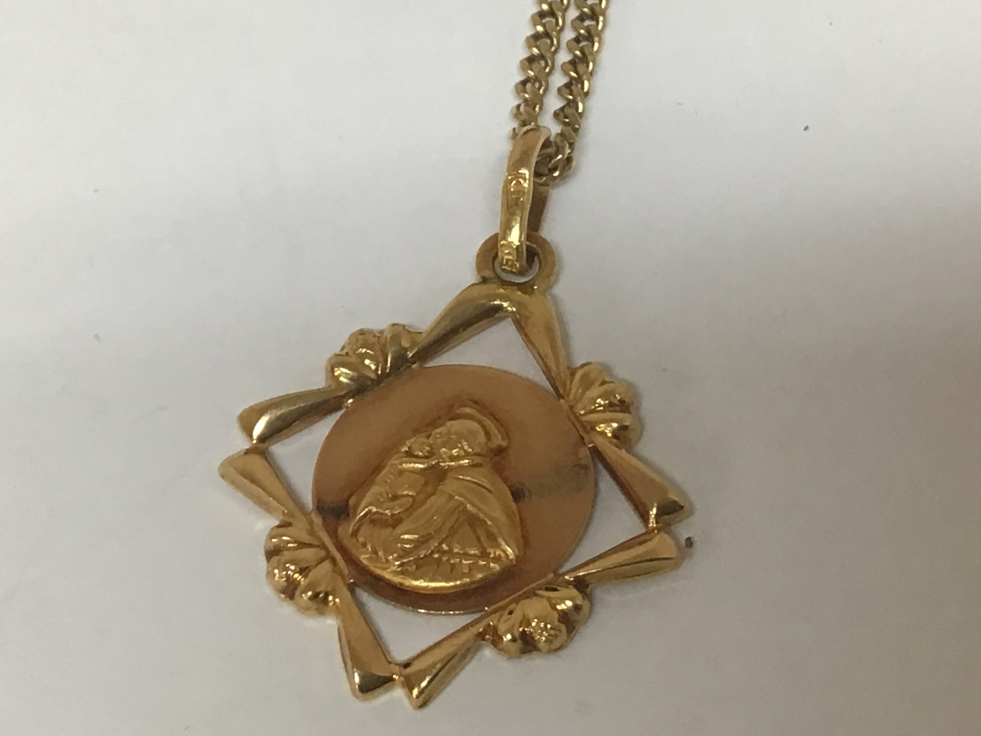 An 18carat gold chain with attached pendent Religious theme total weight 9.5g