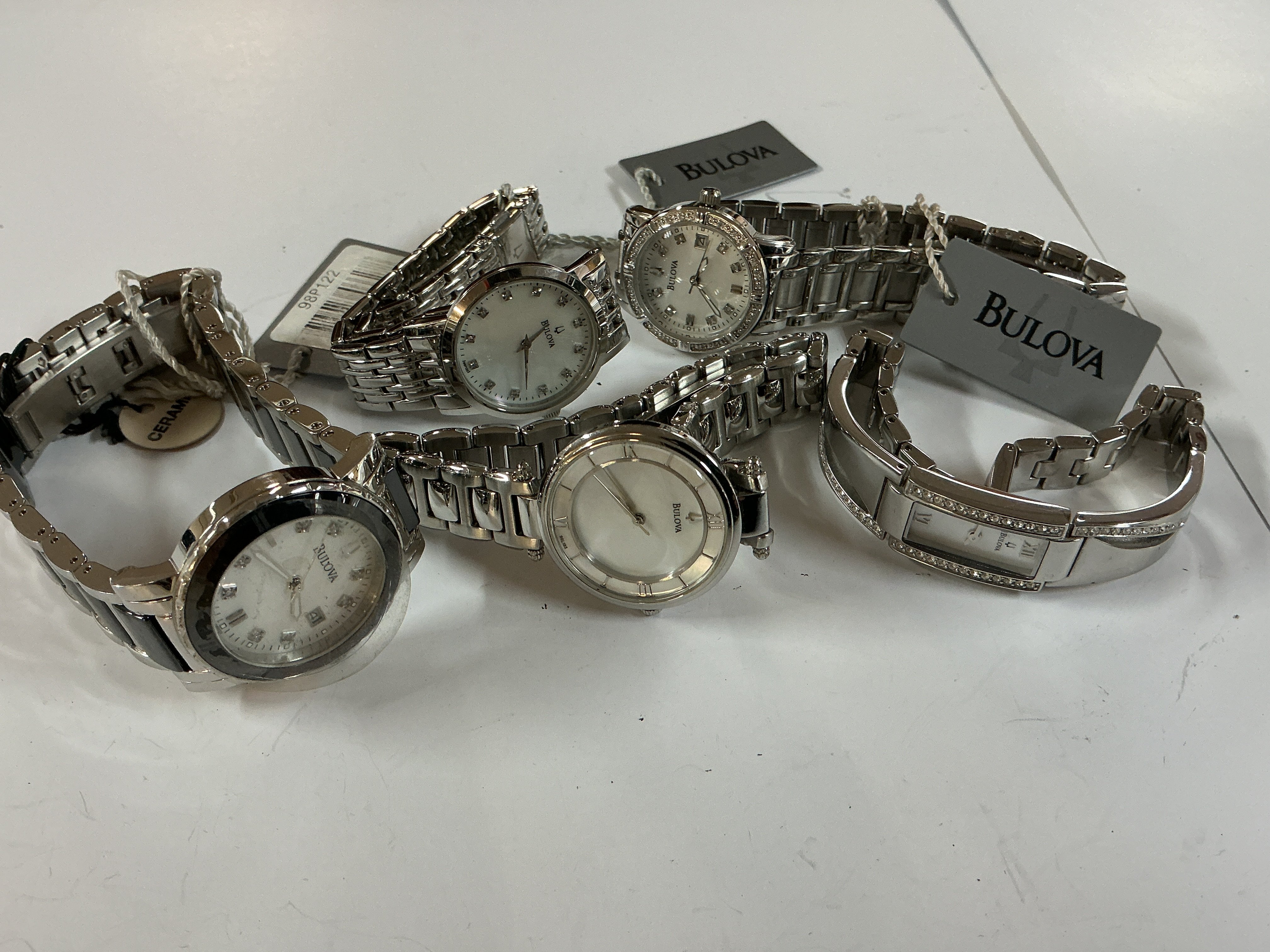 five ladies bulova watches some with tags.