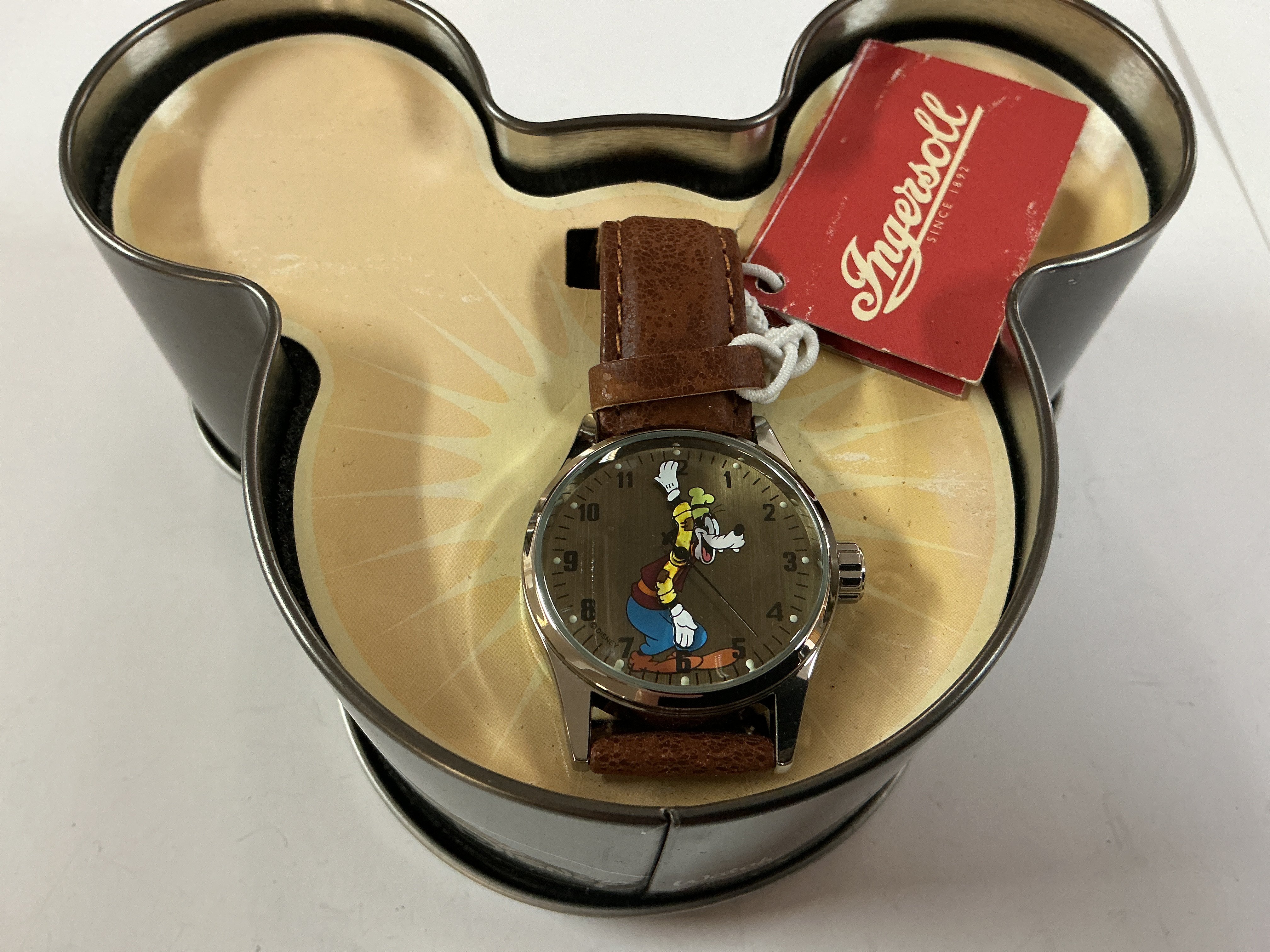 a Disney goofy ingersoll watch on a leather strap.