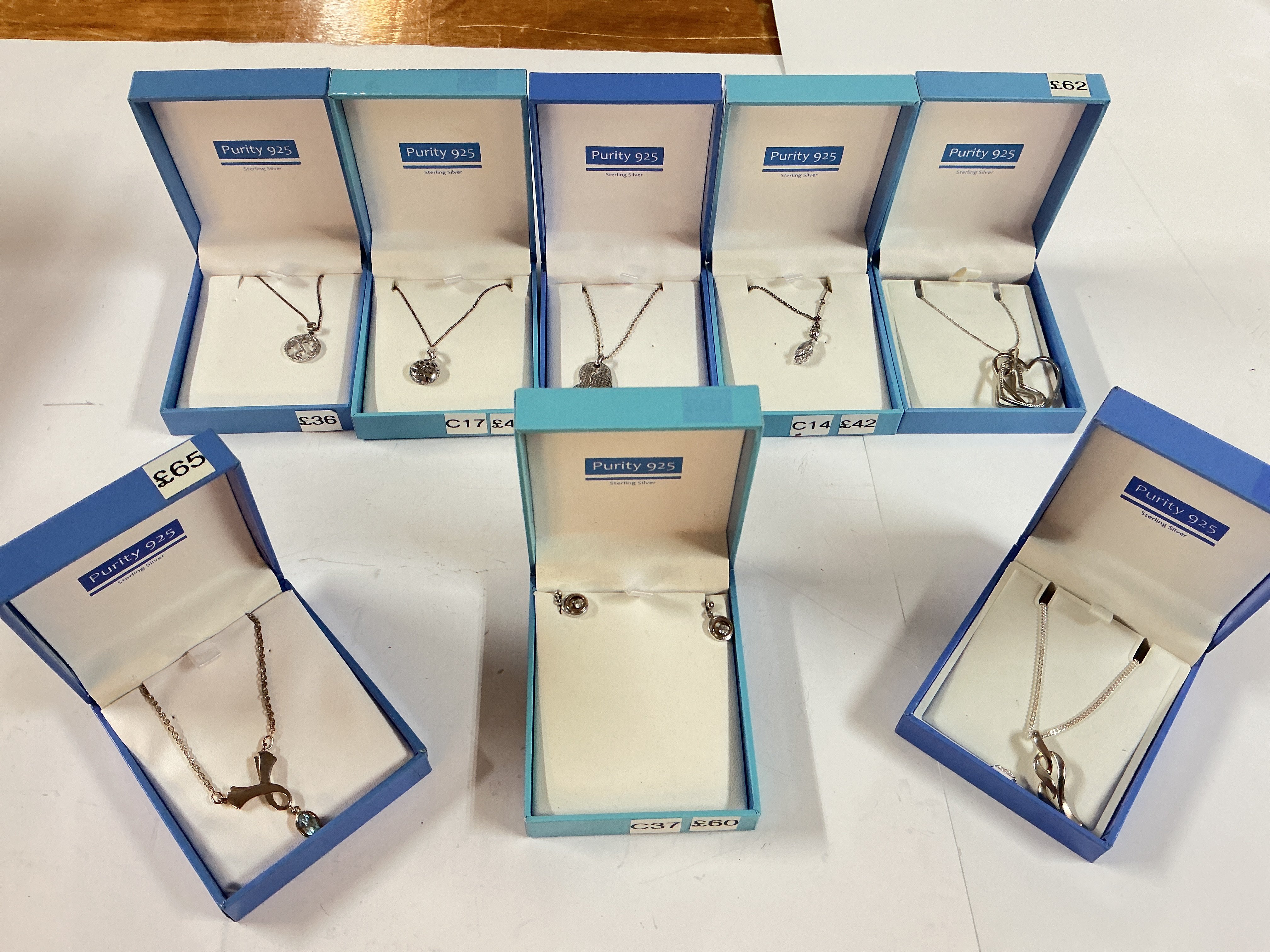 a collection of mixed silver chains and pendants as well as a silver clasped pearl bracelet.