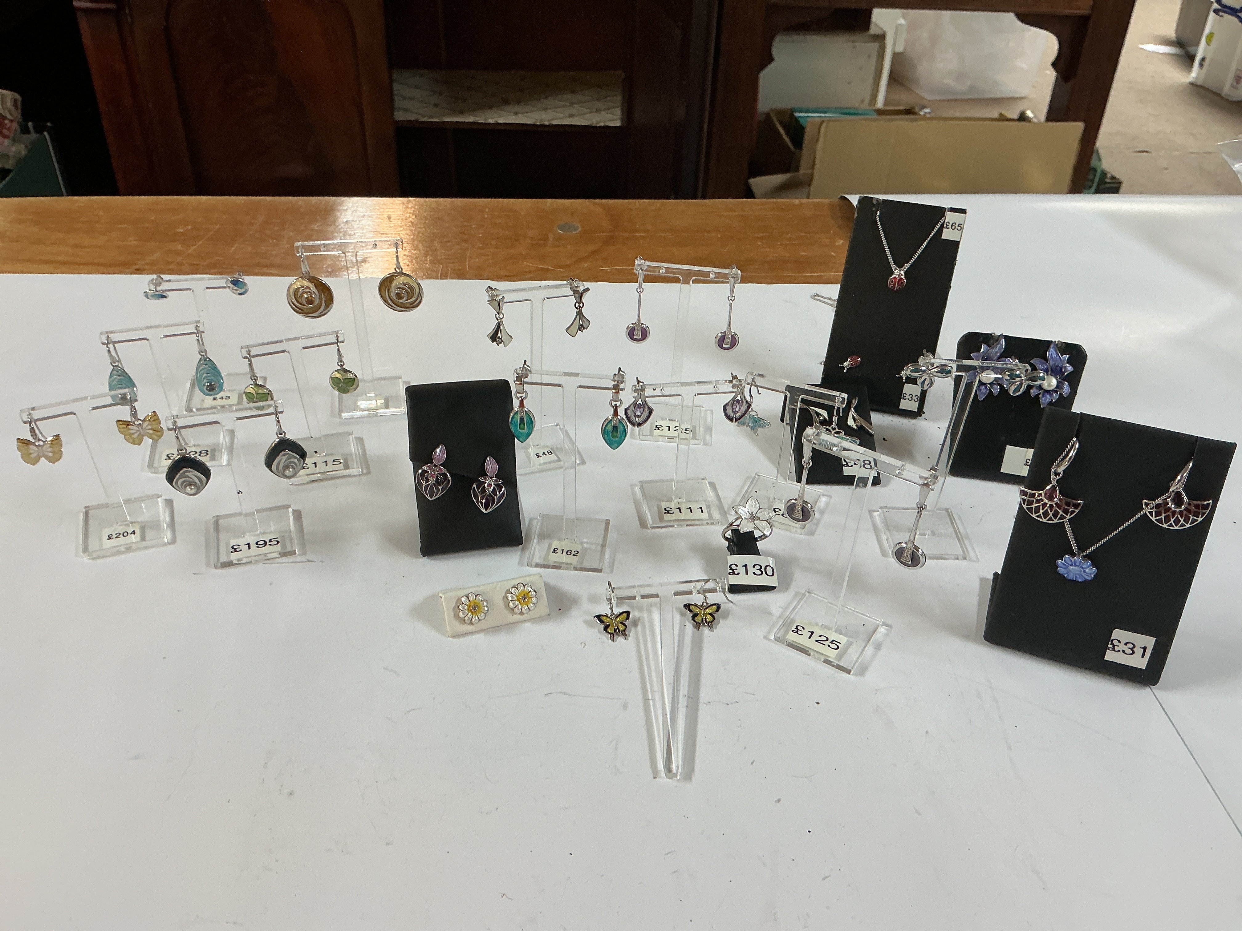 a mixed collection of enamel earrings and pendants.