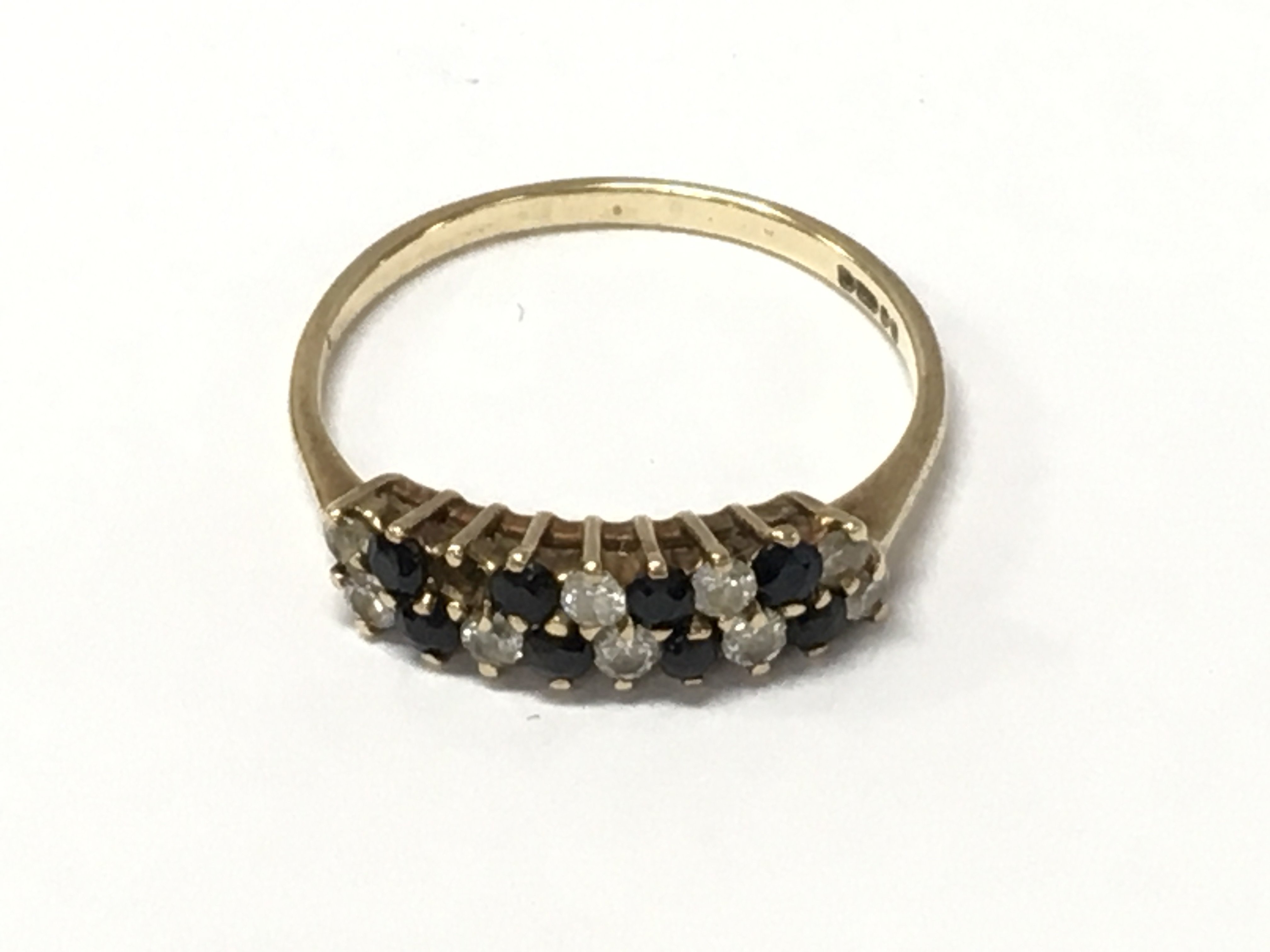 A 9ct gold ring set with sapphire and alternating small diamonds . Size R. Total weight 1.7g Postage category A