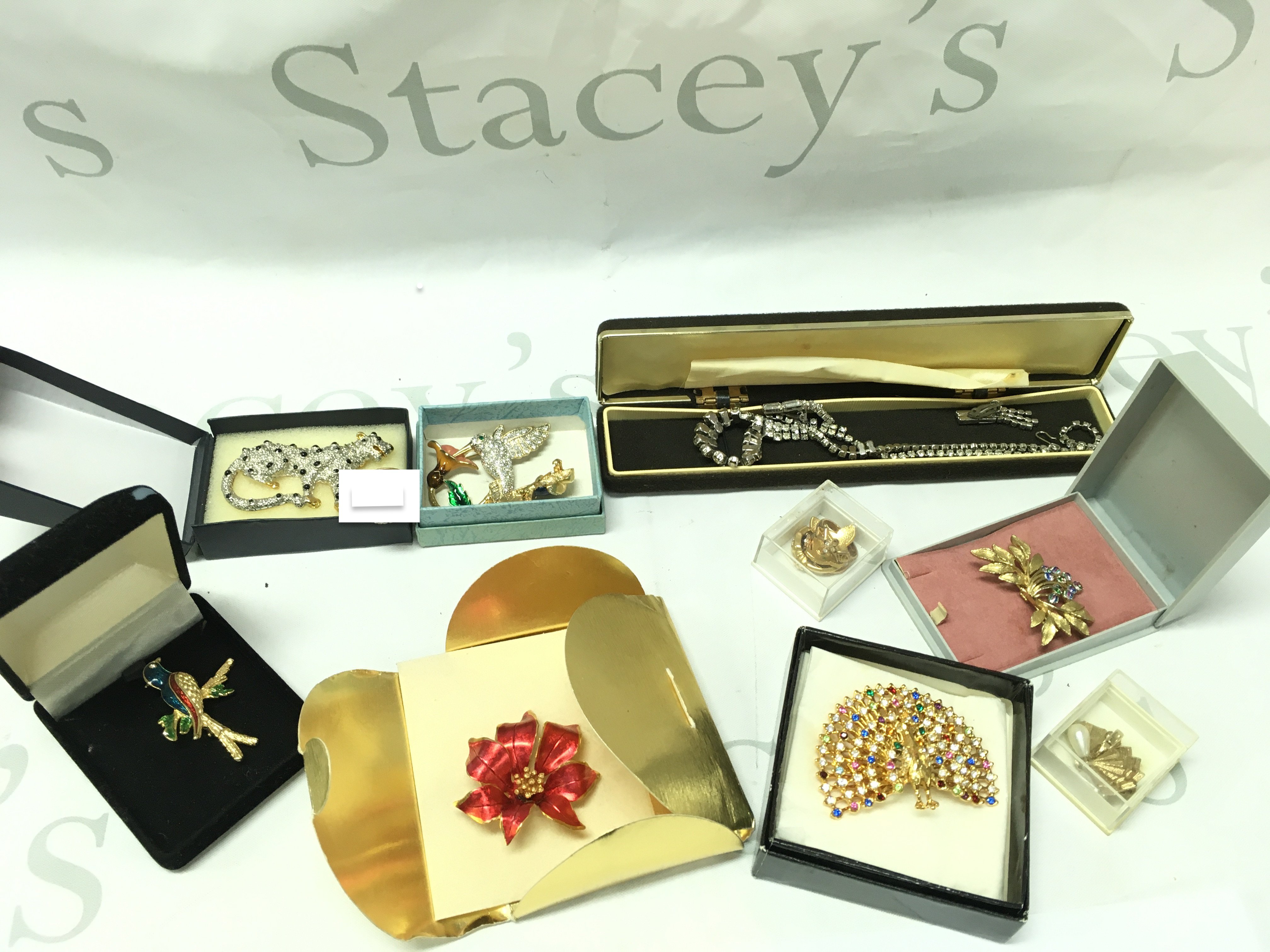 A Collection of costume Jewellery including brooches, silver ring, earrings etc . Postage category b