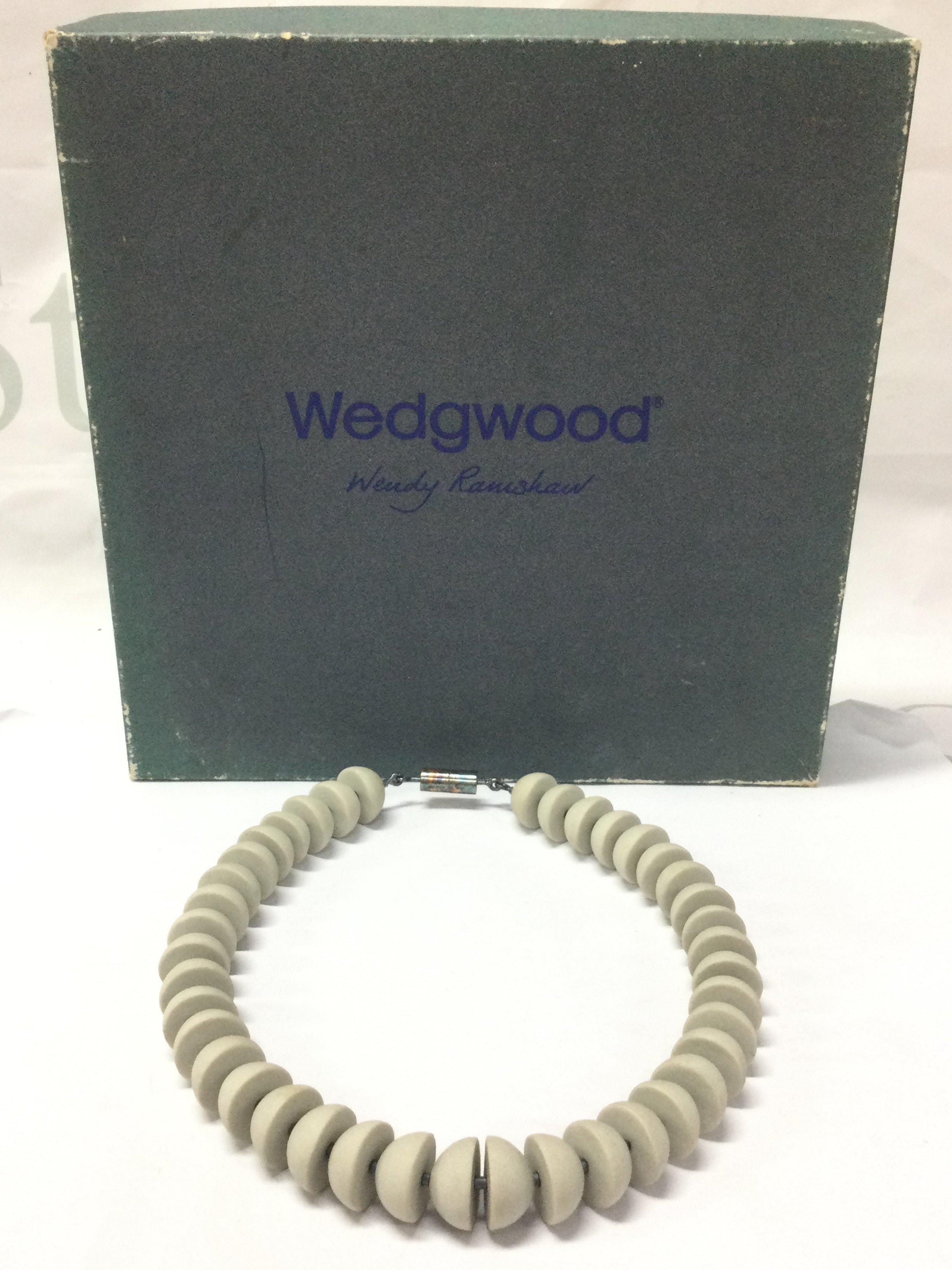 A boxed Wendy Ramshaw (1939-2018) necklace with Wedgwood hand turned beads ,a silver clasp hallmarked maker J.W and signed WR. 13cm wide approximately . Postage category B