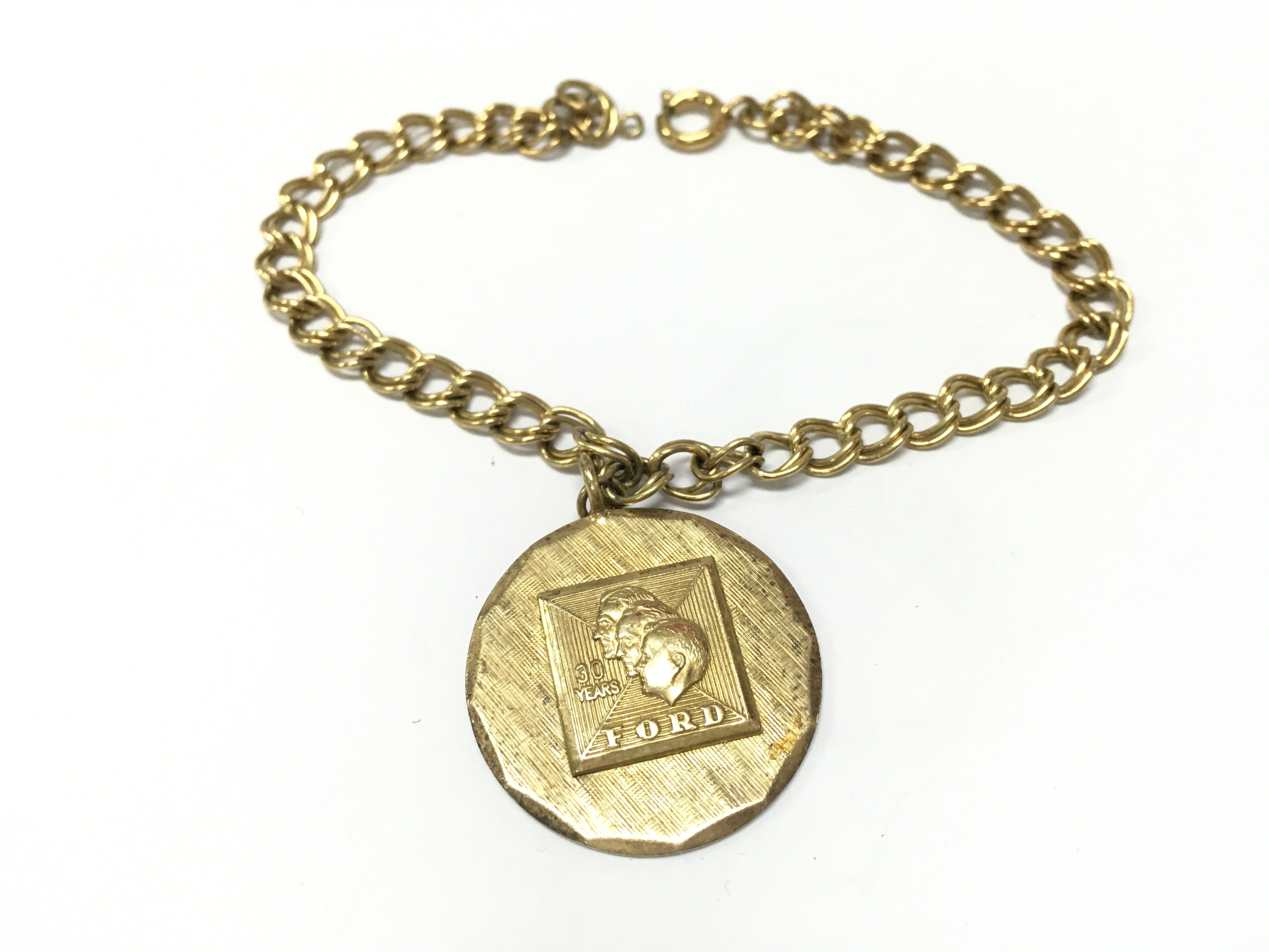 A silver gilt fords long service pendant on a gold plated chain . Postage category A