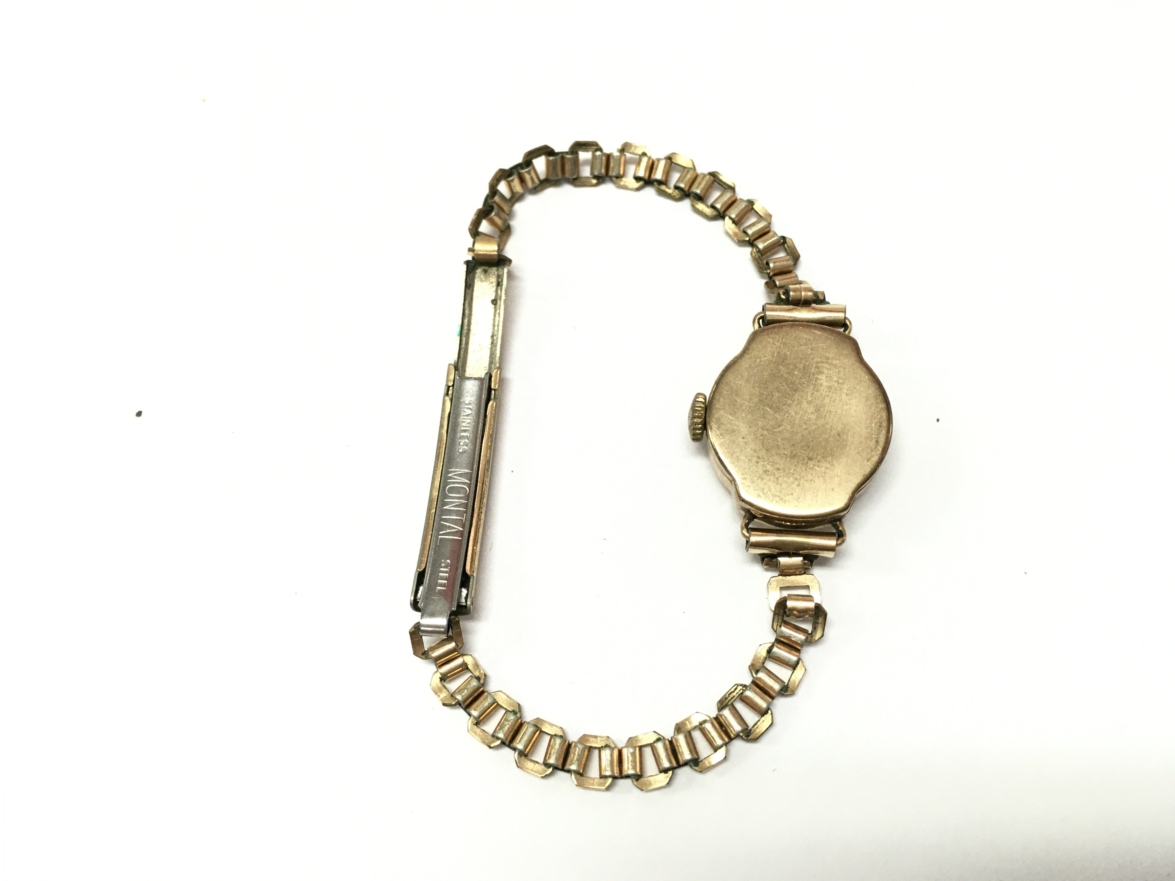 A 9ct gold cased ladies Avia watch with a gold plated bracelet . Postage catA
