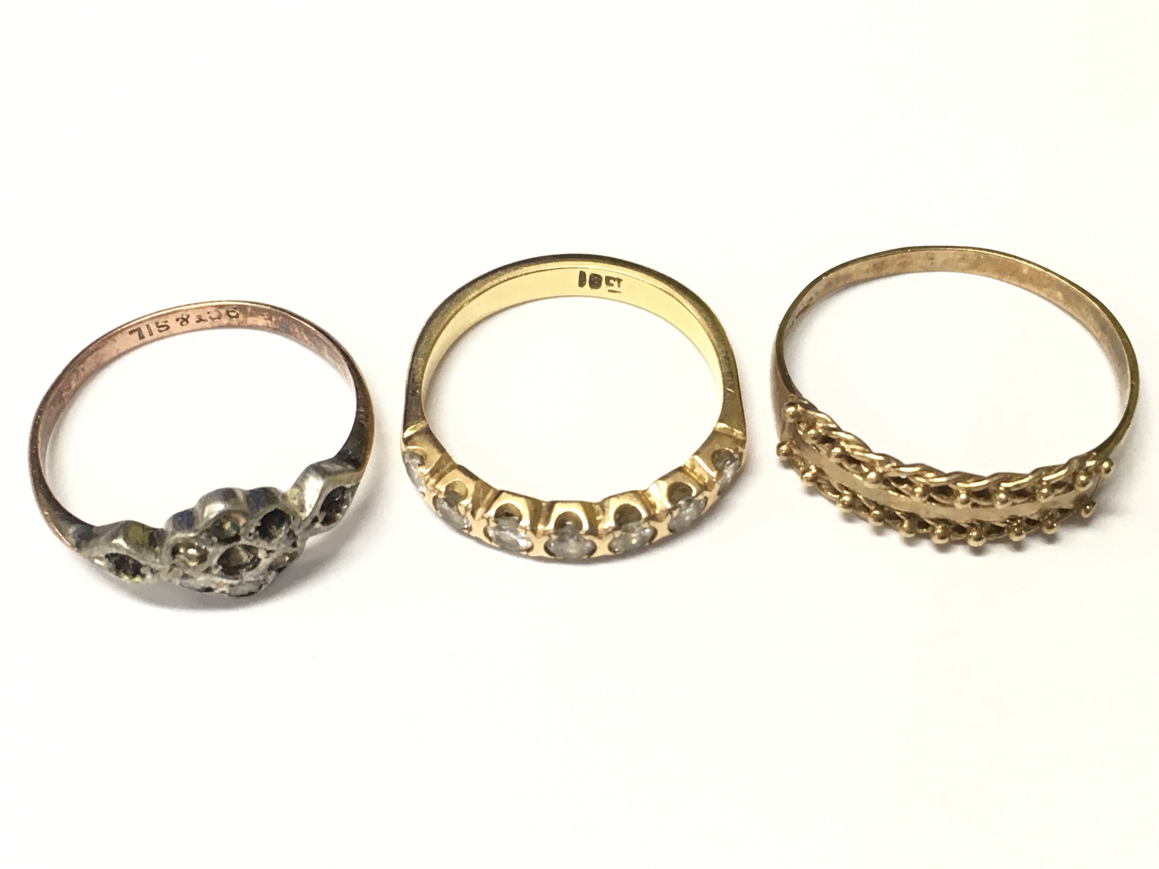 An 18ct gold rings row set with white stones and two other rings, Approx weight of 18ct gold ring 2.81 grams.