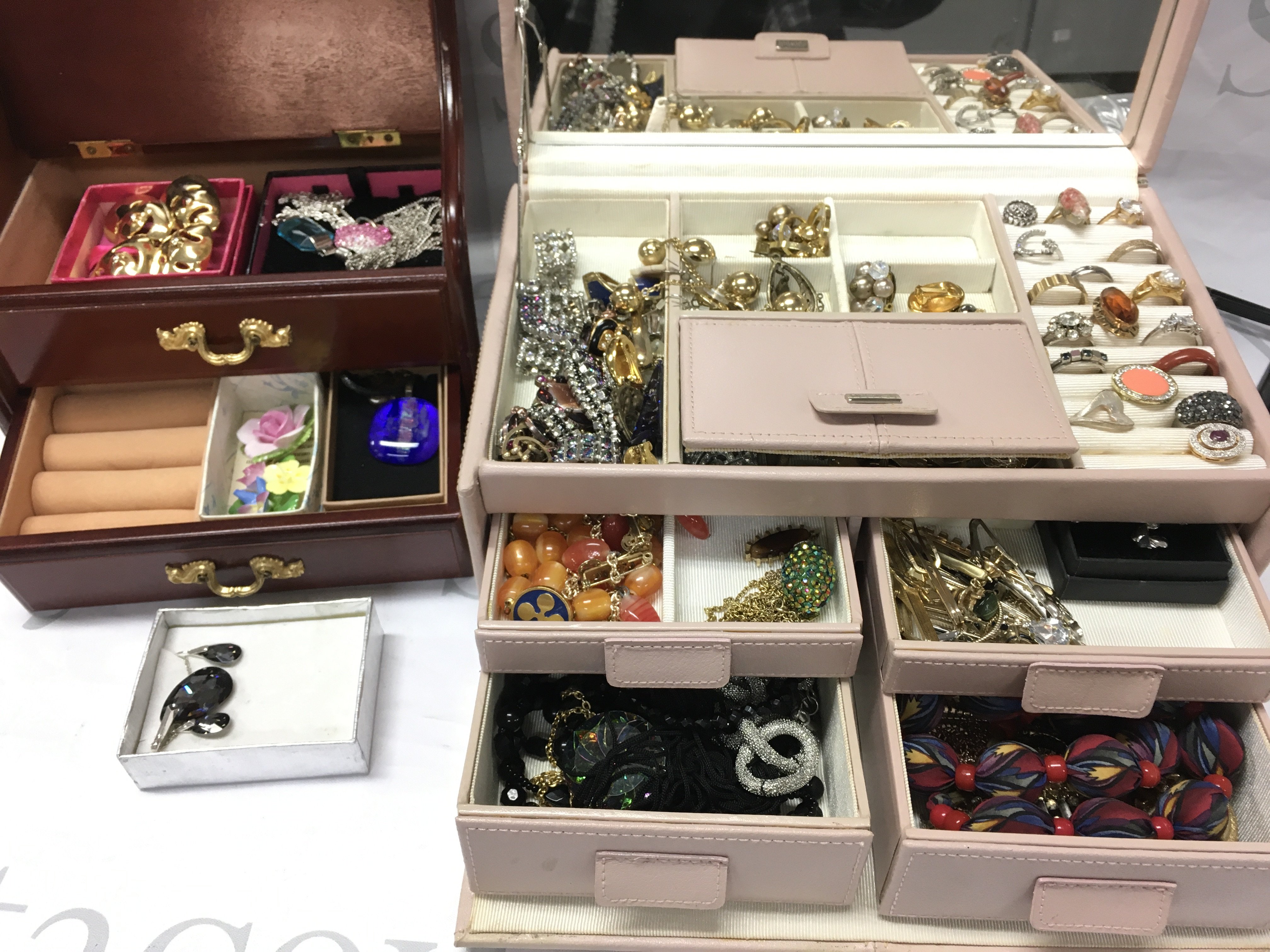 A large collection of costume jewellery including two boxes of brooches, necklaces, earrings, rings etc . Postage catC