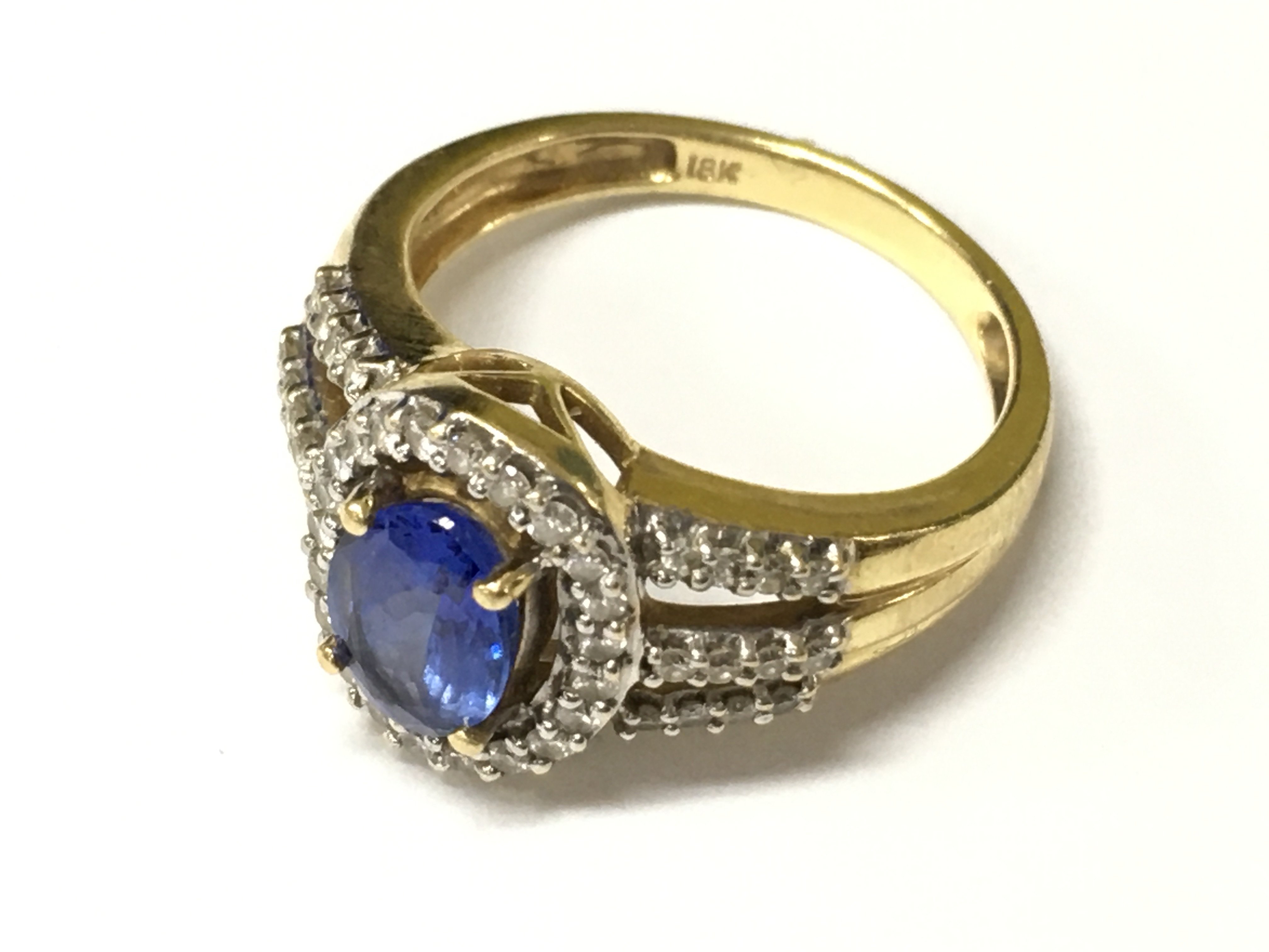 An 18ct gold diamond and tanzanite ring, size O. Approx weight 6.17 grams.