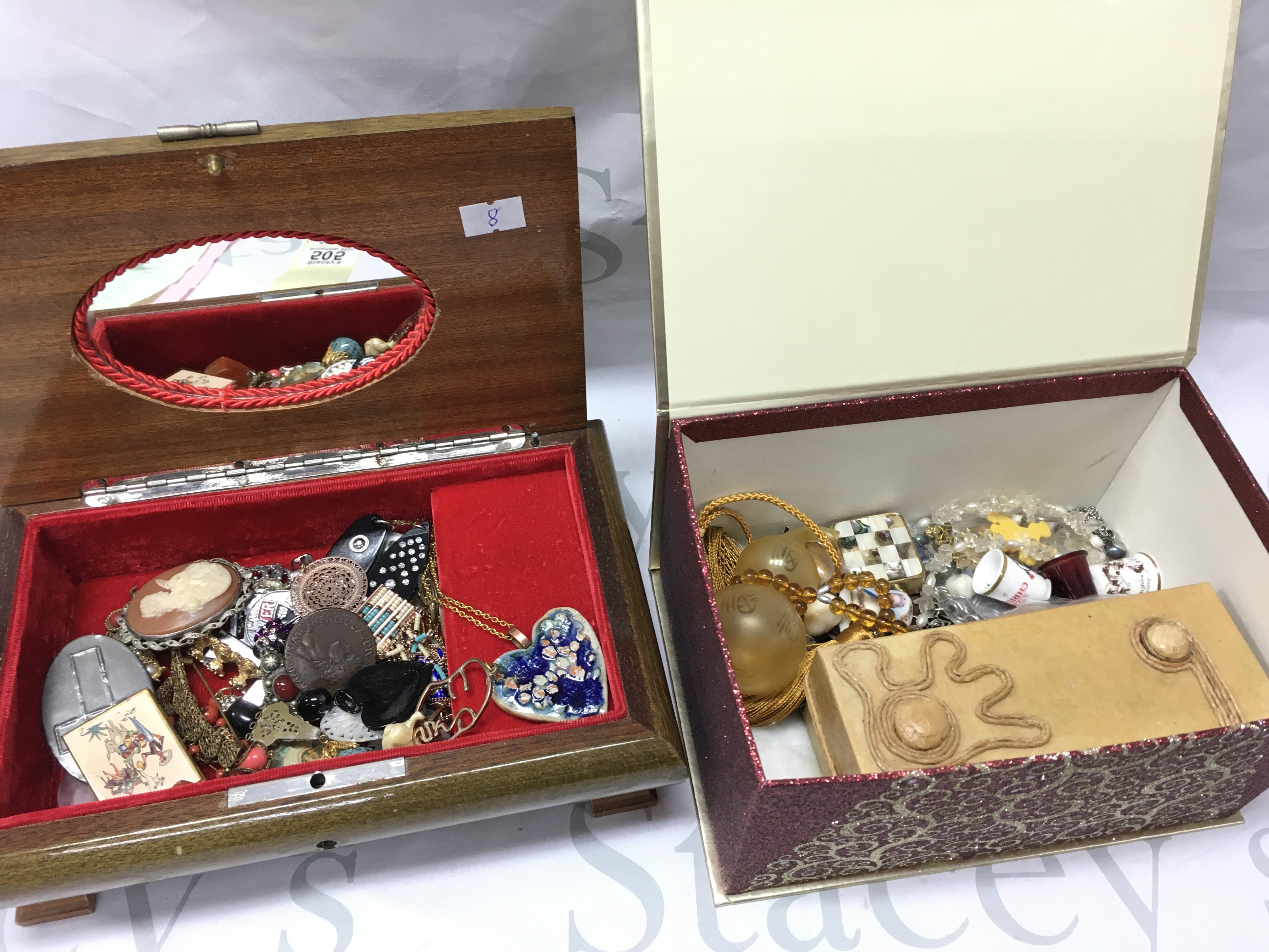 Two boxes of vintage jewellery including pendants, brooches , Thimbles etc. postage category C