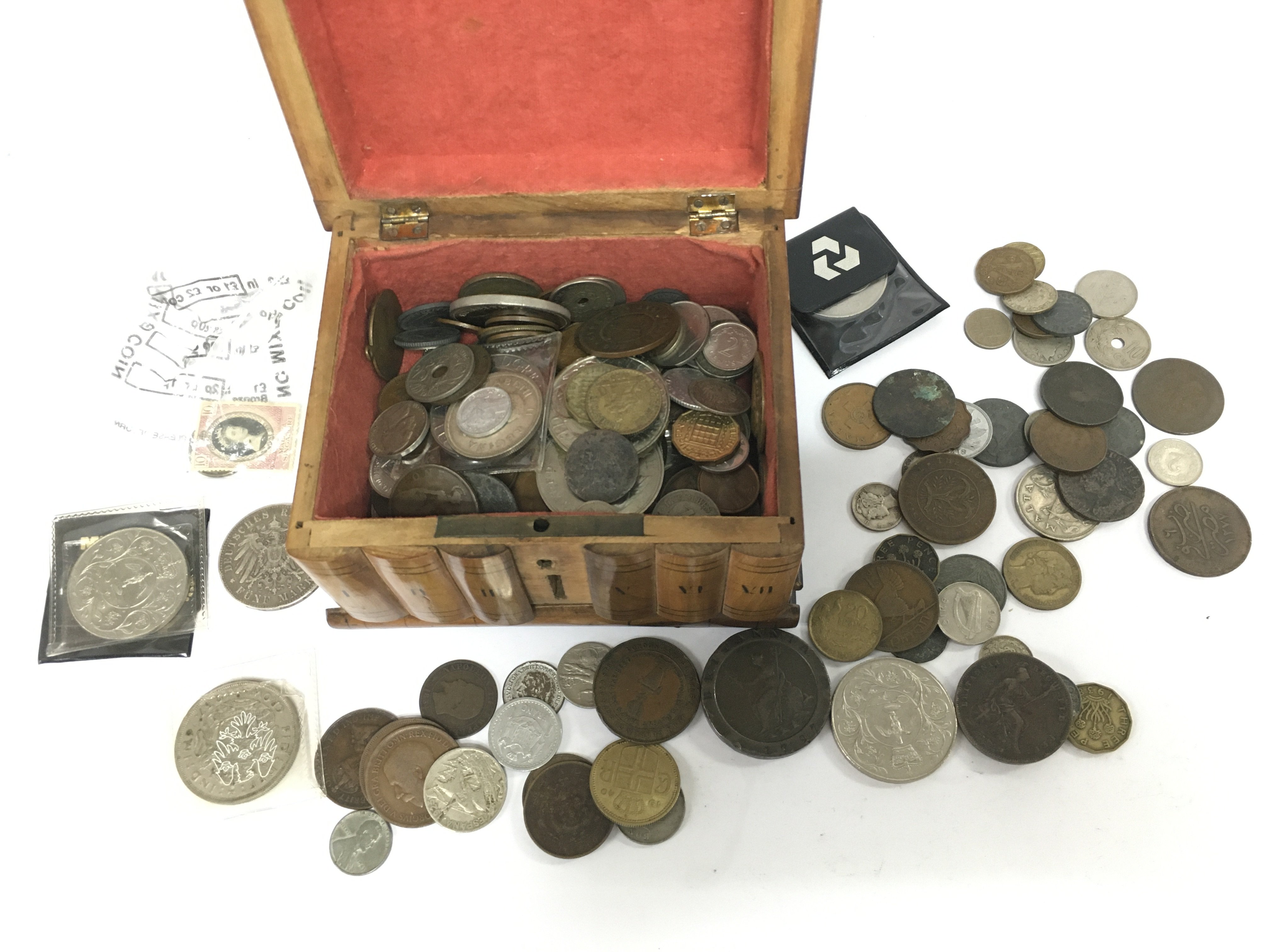 An olive wood box containing various coins. Shipping category D.