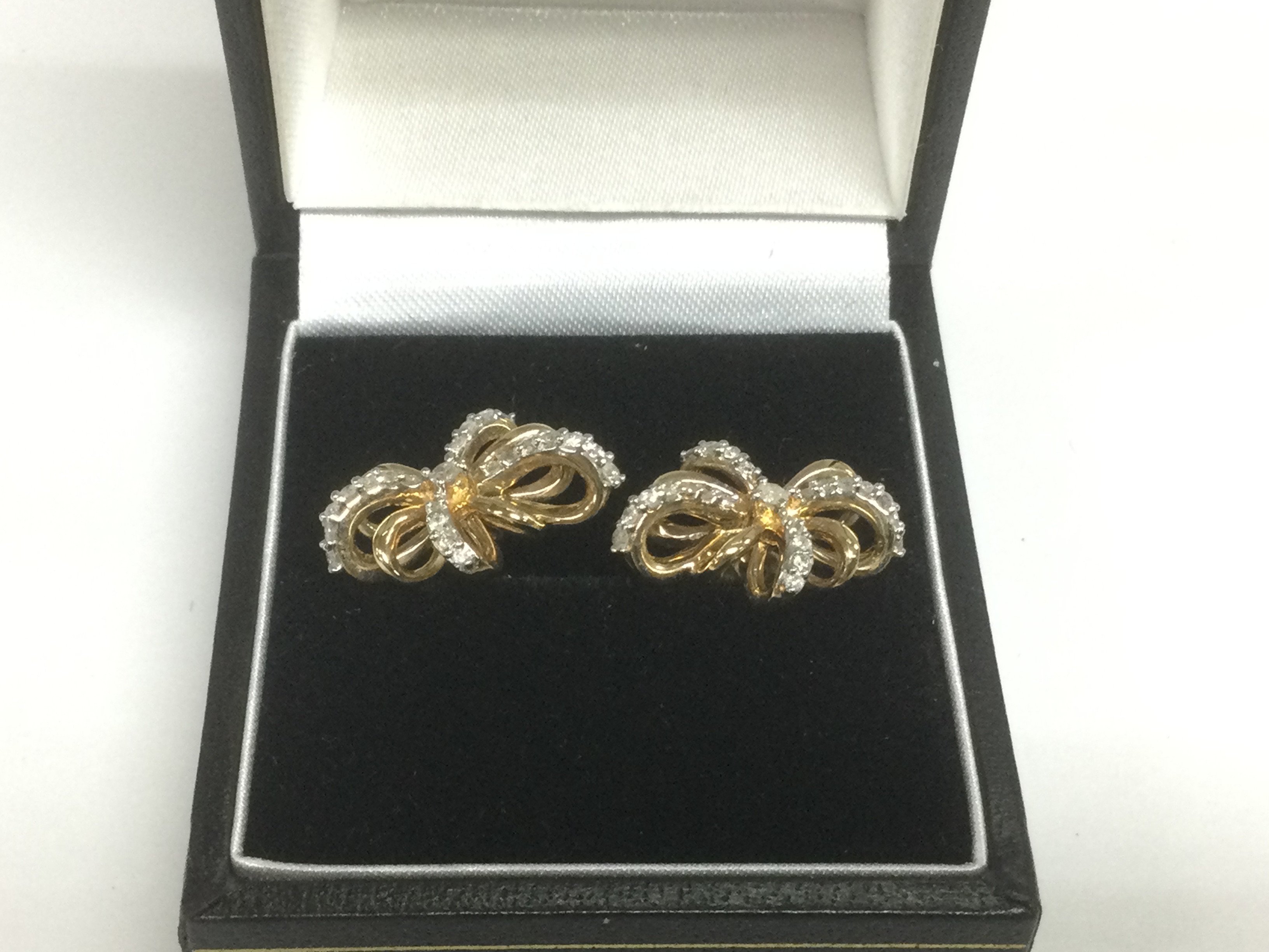 A pair of 10k gold and diamond bow earrings, approx 3.7g. Shipping category A.