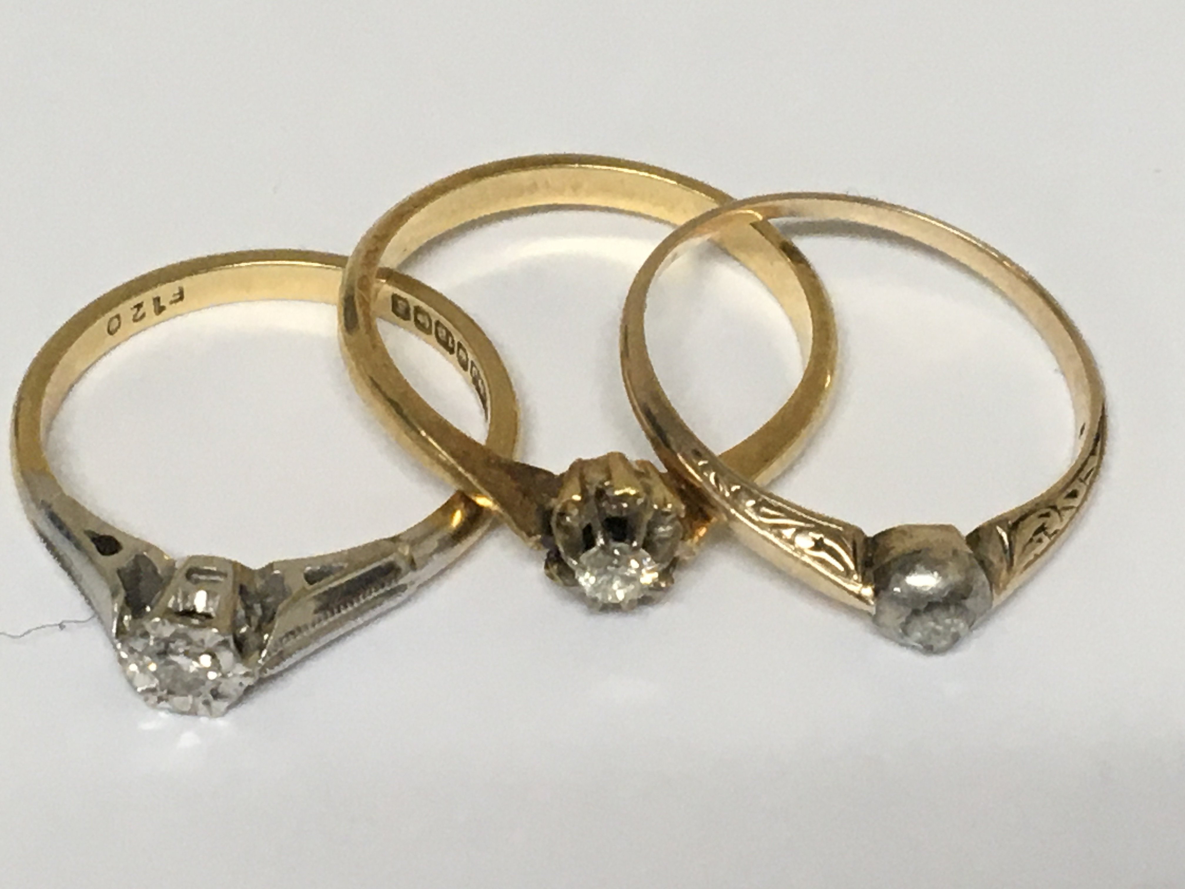 Three 18carat gold rings set with Small Solitaire diamonds weight 7g