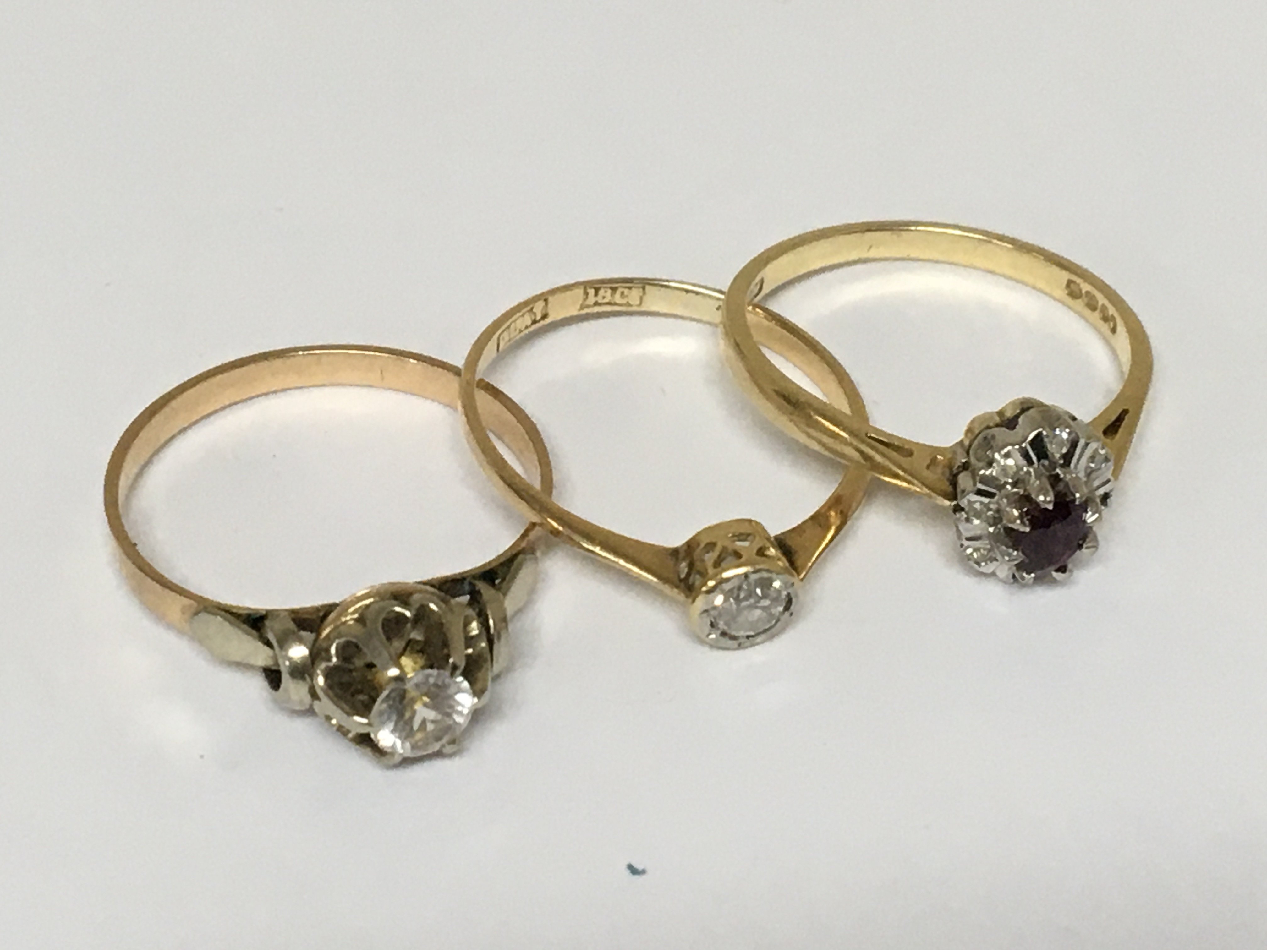 Three 18carat gold rings set with a solitaire diamond and a ruby weight 6g