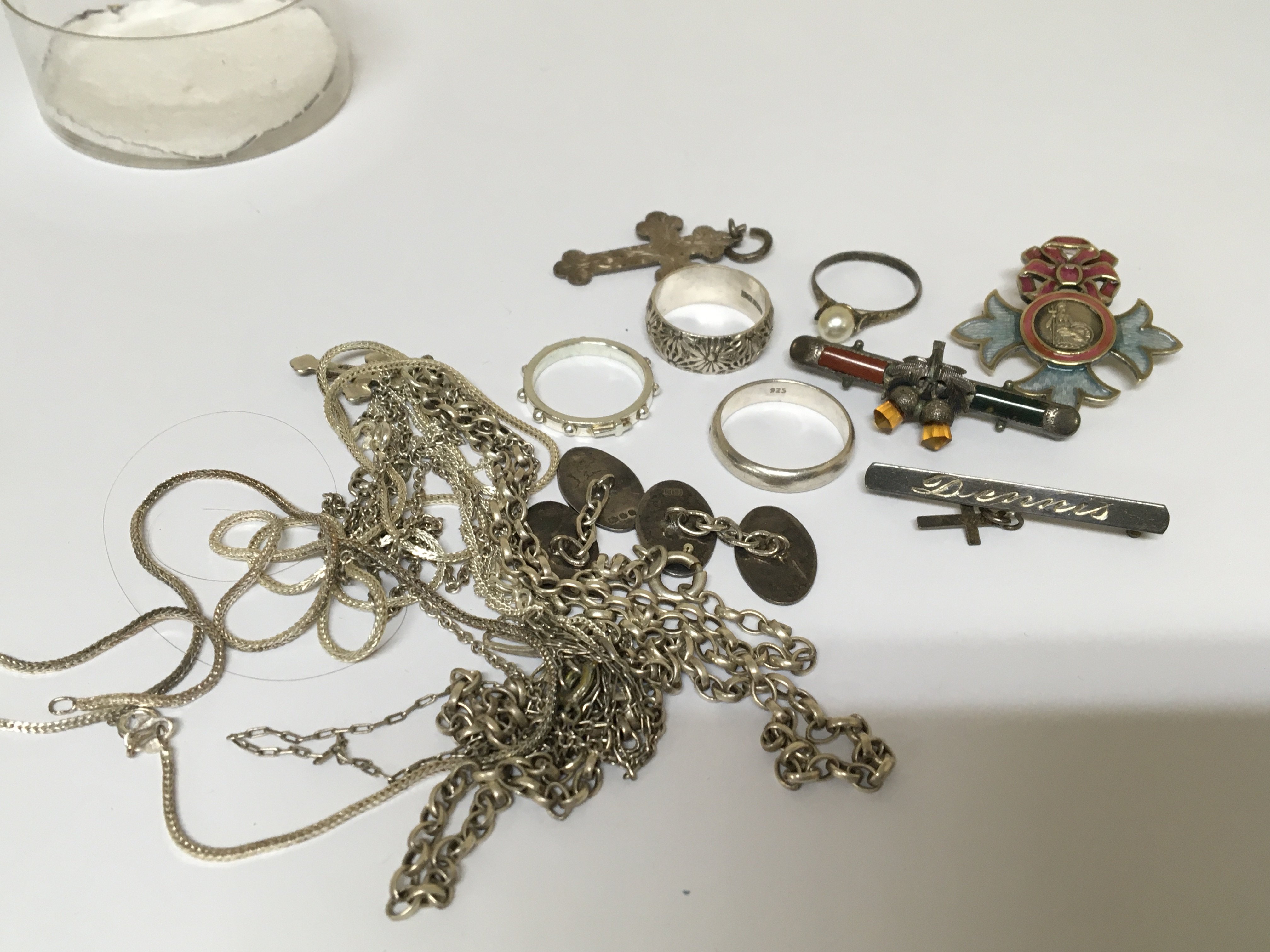 A collection of silver jewellery rings necklaces cufflinks an enamel badge For God and the Empire