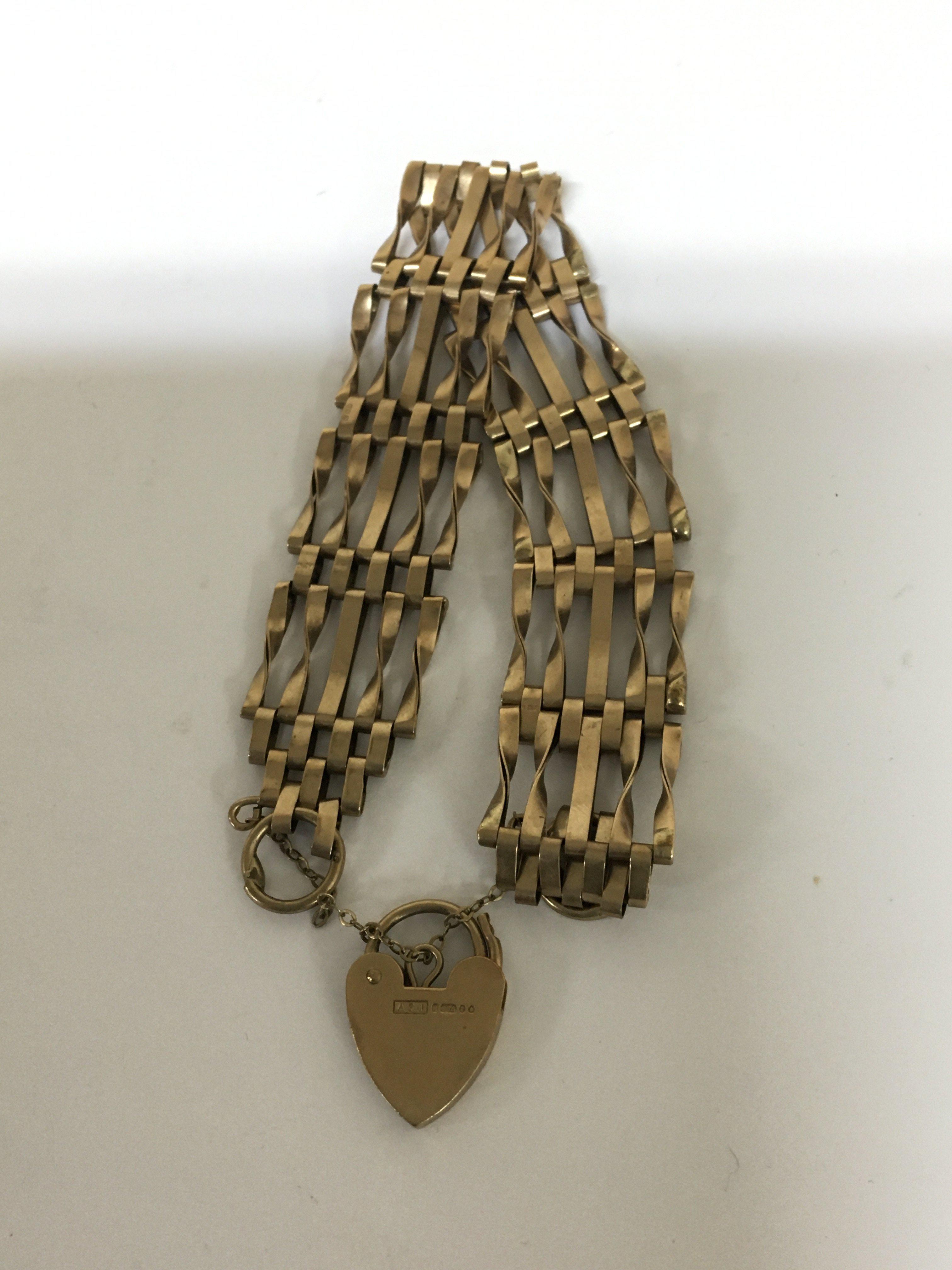 A 9carat gold gate bracelet with a padlock clasp. Weight 12.5g