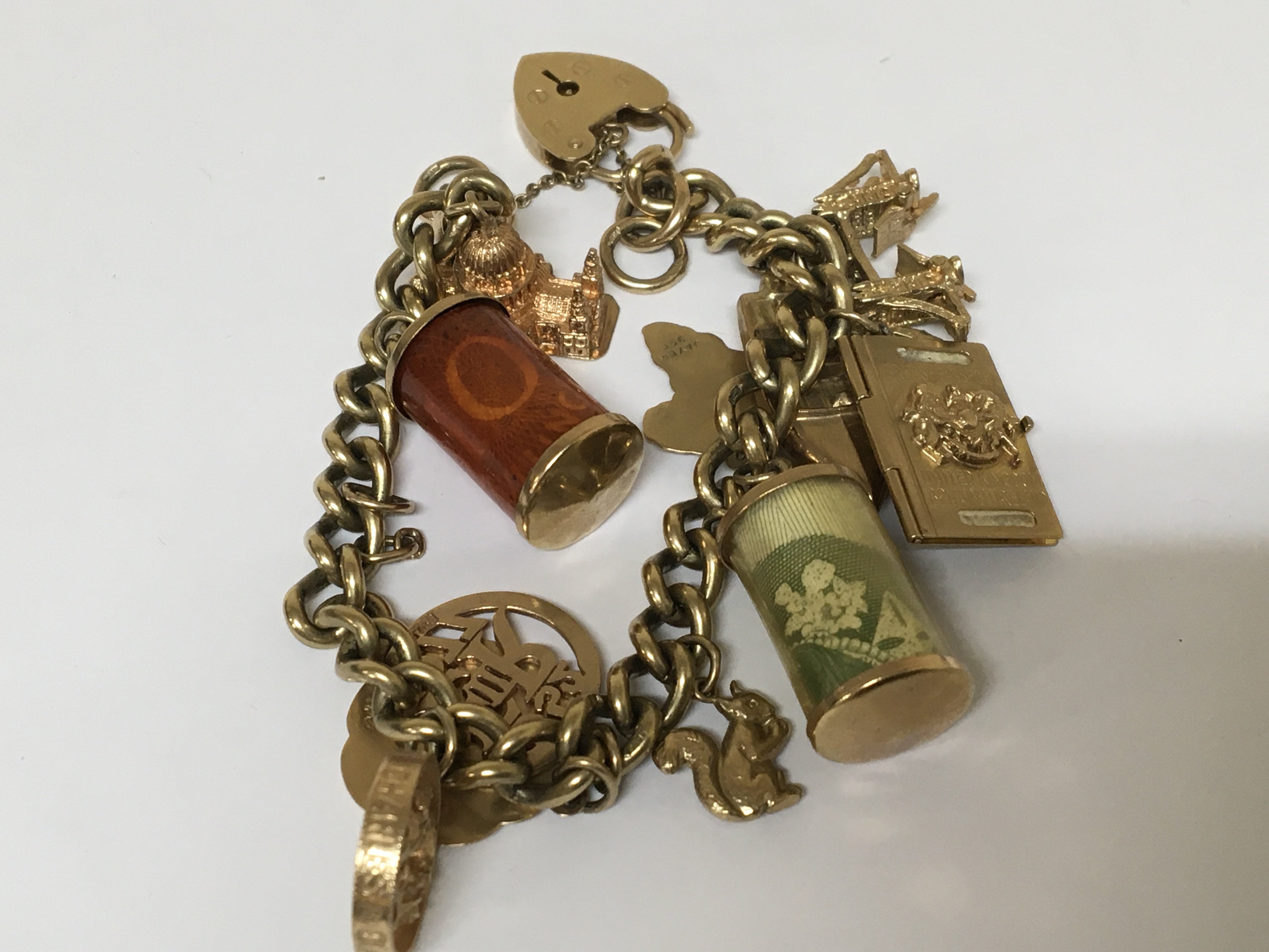 A 9carat gold charm bracelet with several attached 9carat charms.total weight 48.5g