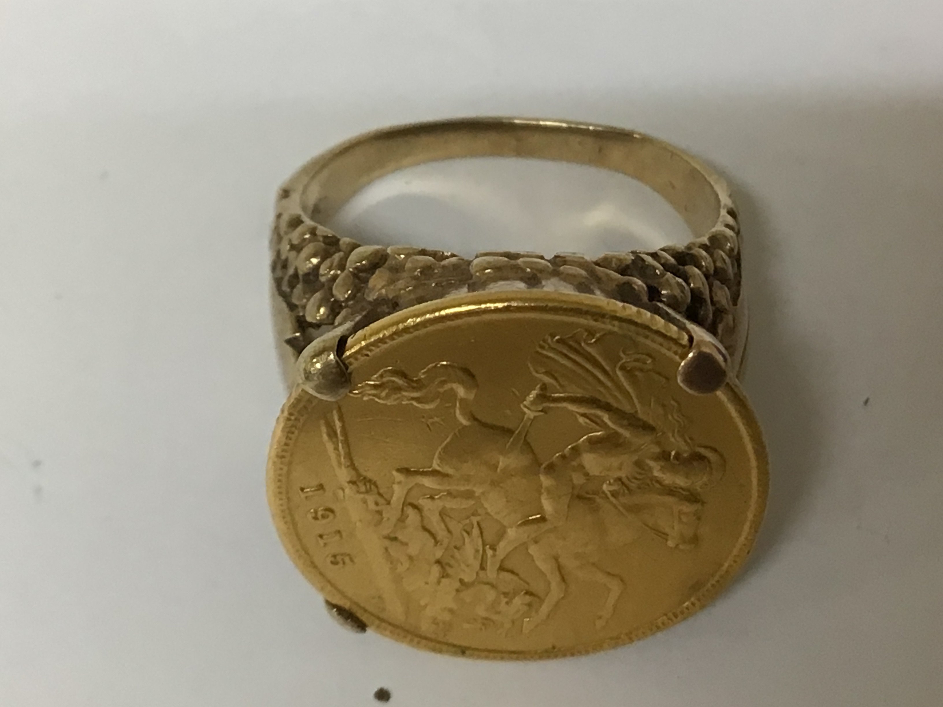 A 9carat gold ring set with a 1915 half sovereign. Total weight 9g