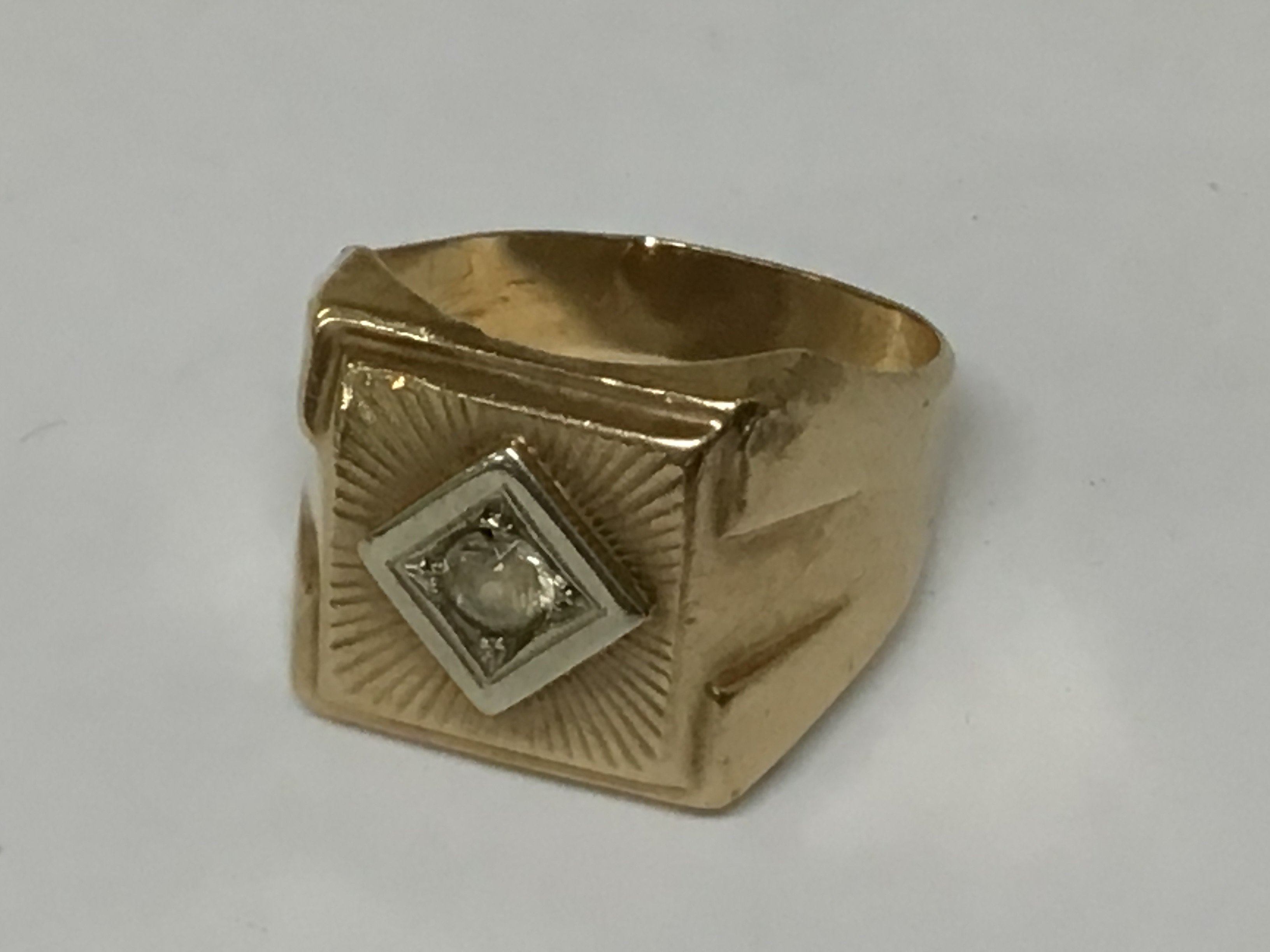 A Gents gold ring unmarked set with an old cut diamond.