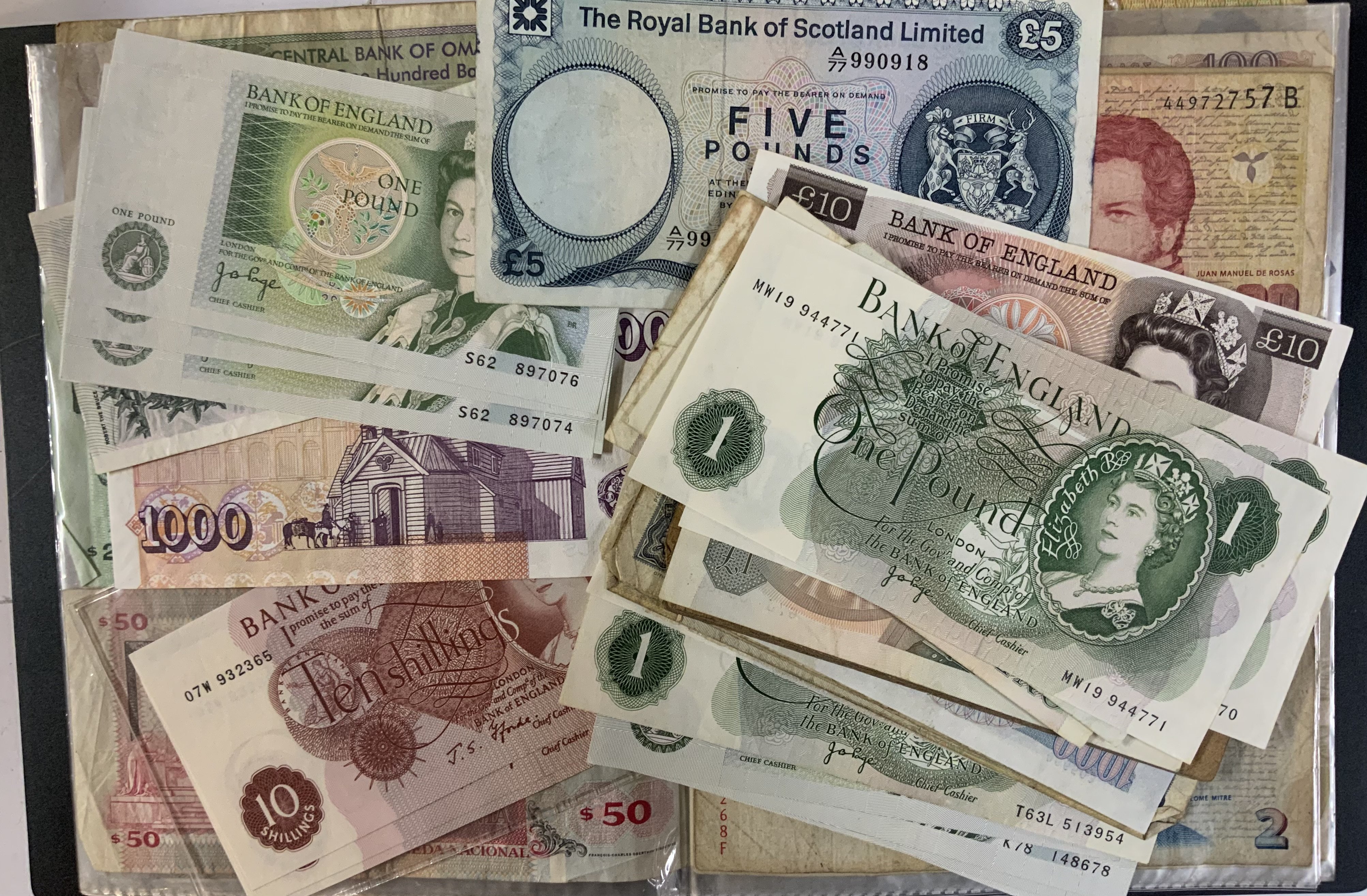 A mixed lot of British and world banknotes.