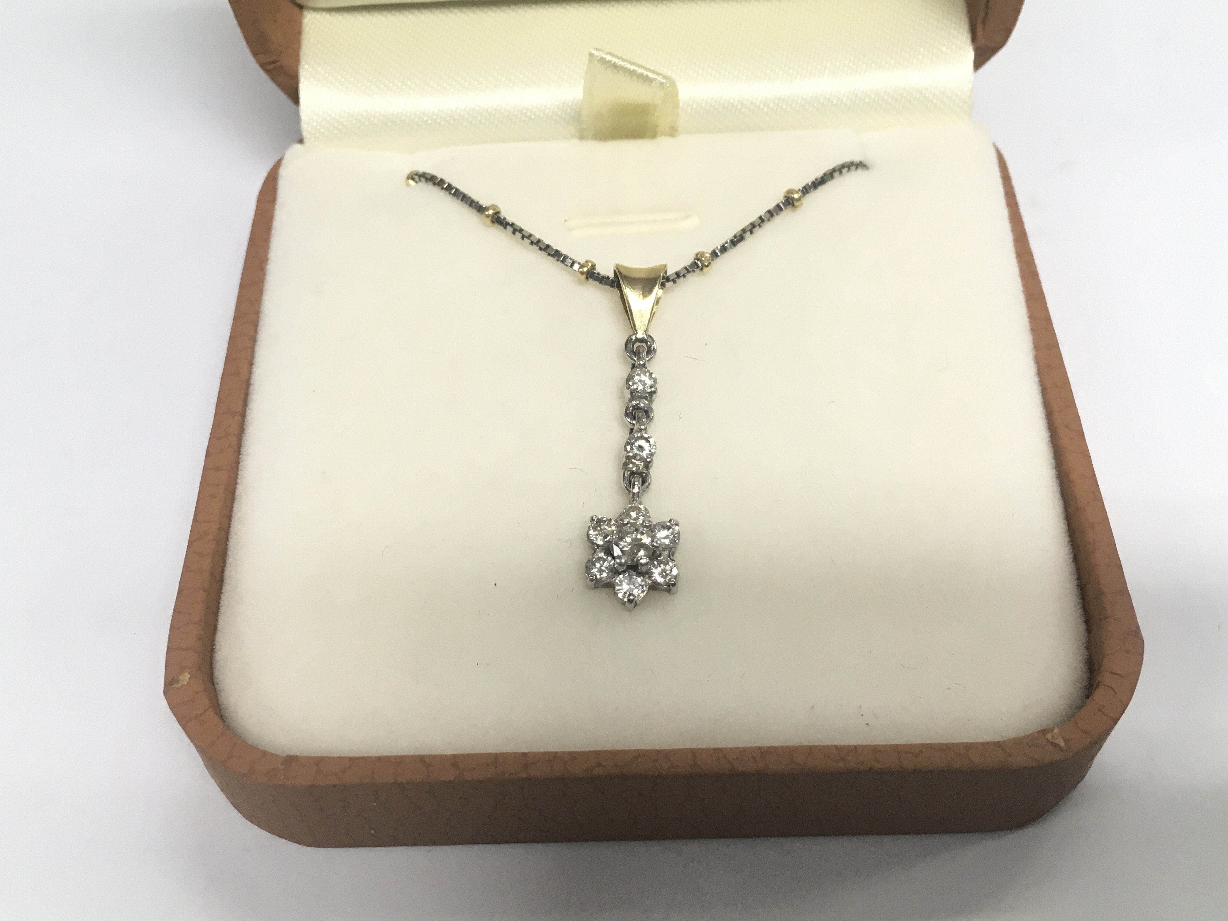 A diamond pendant suspended on an 18ct gold chain, approx 5.5g. Shipping category A.