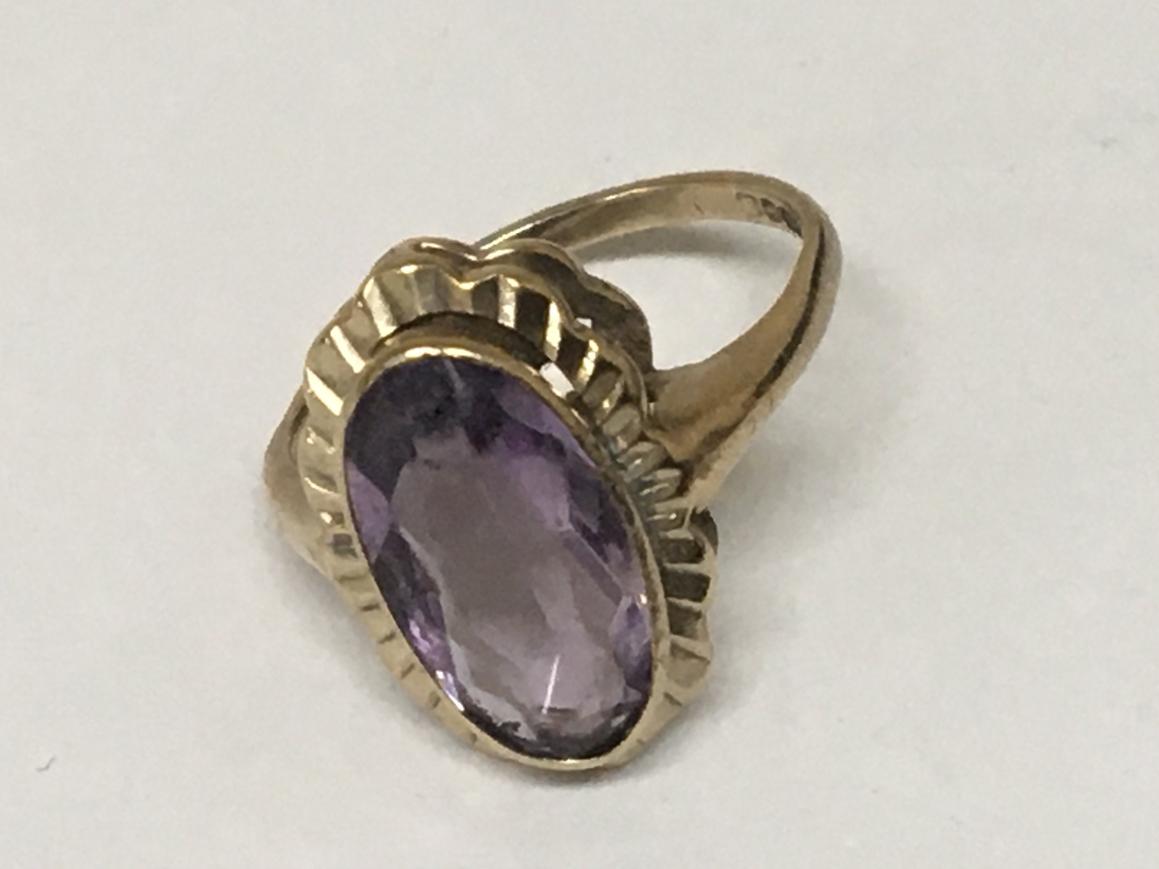 A 9carat gold ring set with an oval amethyst. Weight 4g