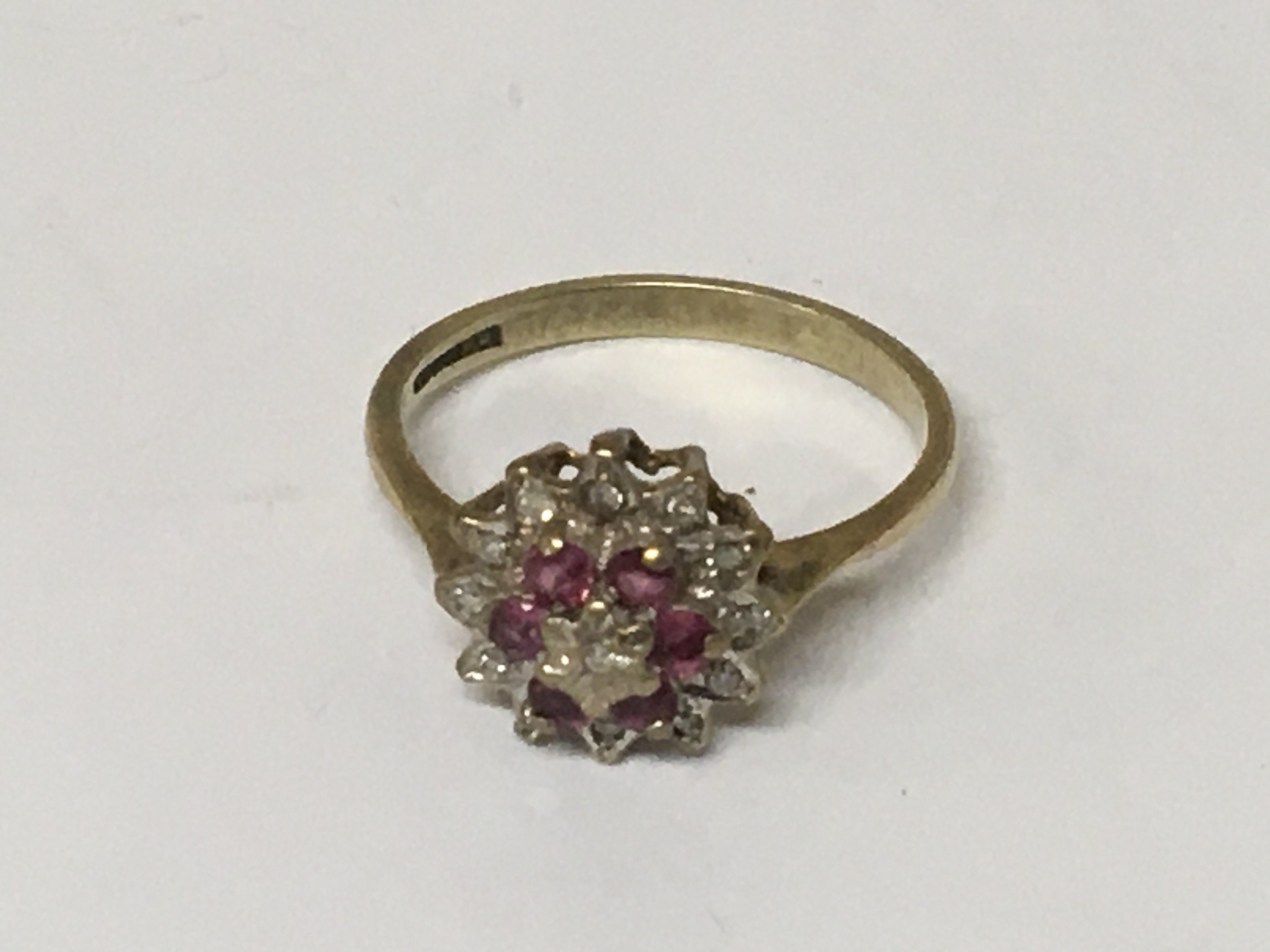 A 9cart gold ring set with a pattern of ruby and diamonds