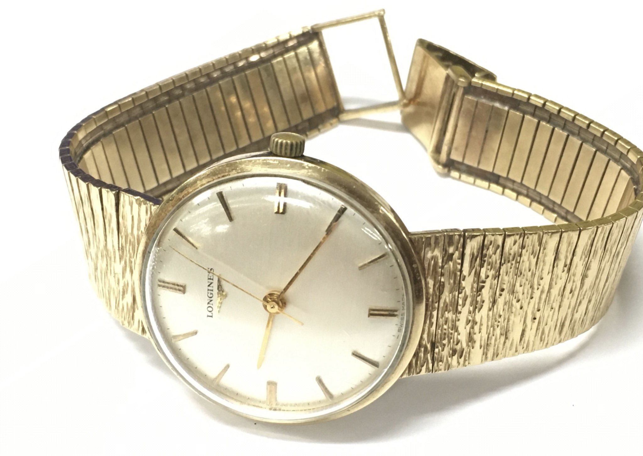 A gents Longines watch with a 9ct gold case and strap. Approx weight 64.55 grams.