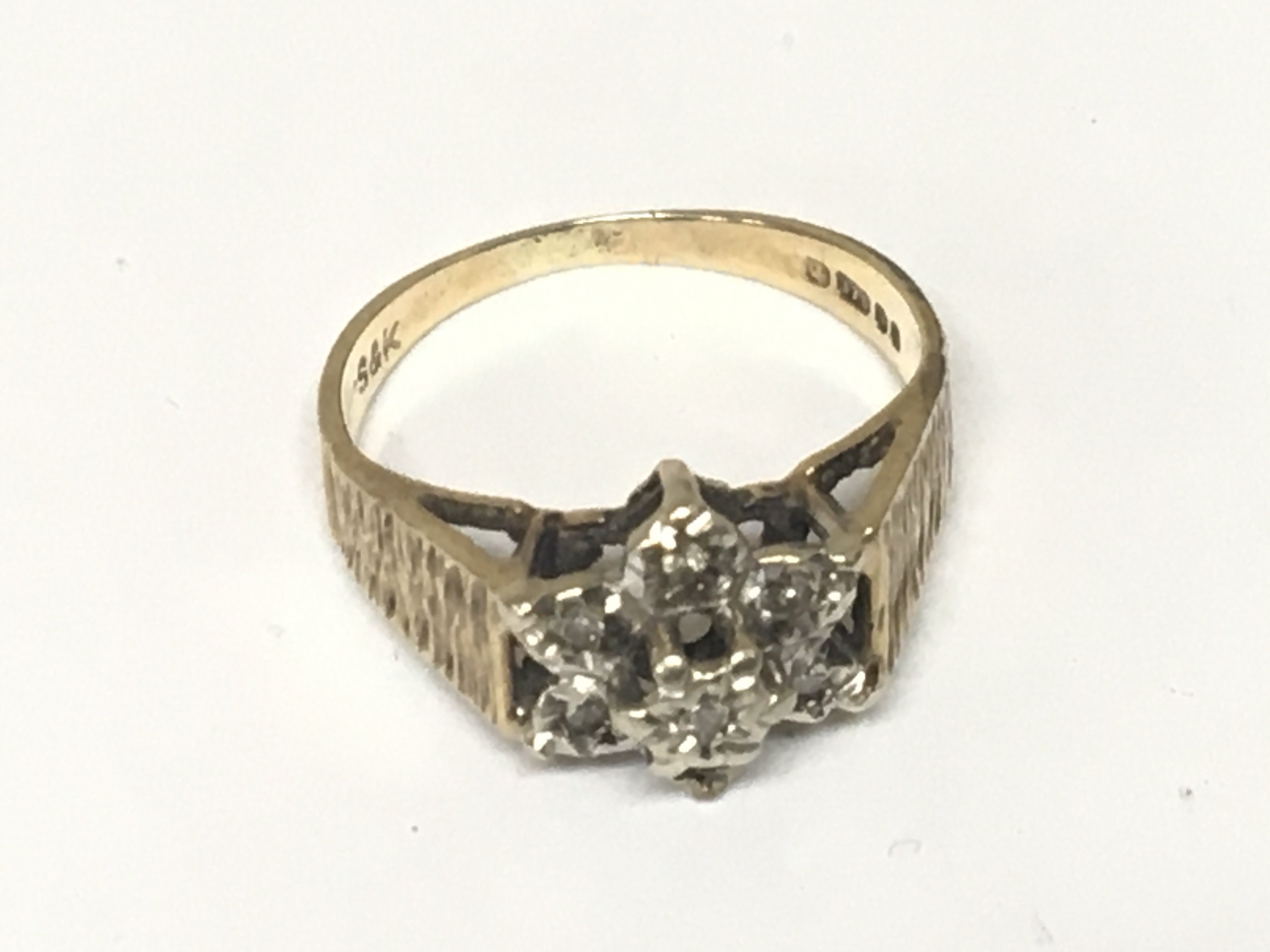 A 9carat gold ring set with a small pattern of diamonds.stone missing weight 2.6g