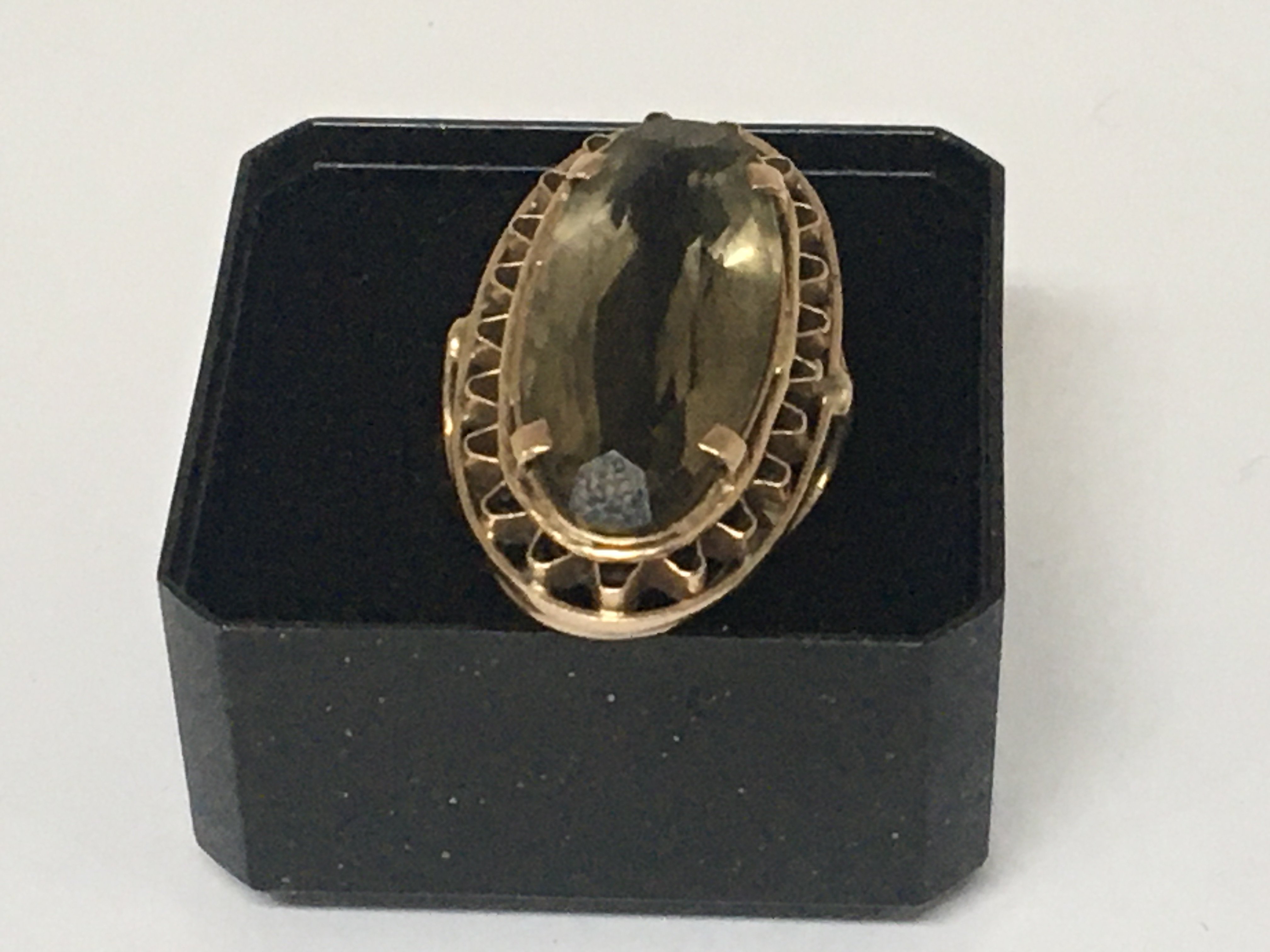 A gold ring set with a large oval smoked quartz. Total weight 8g