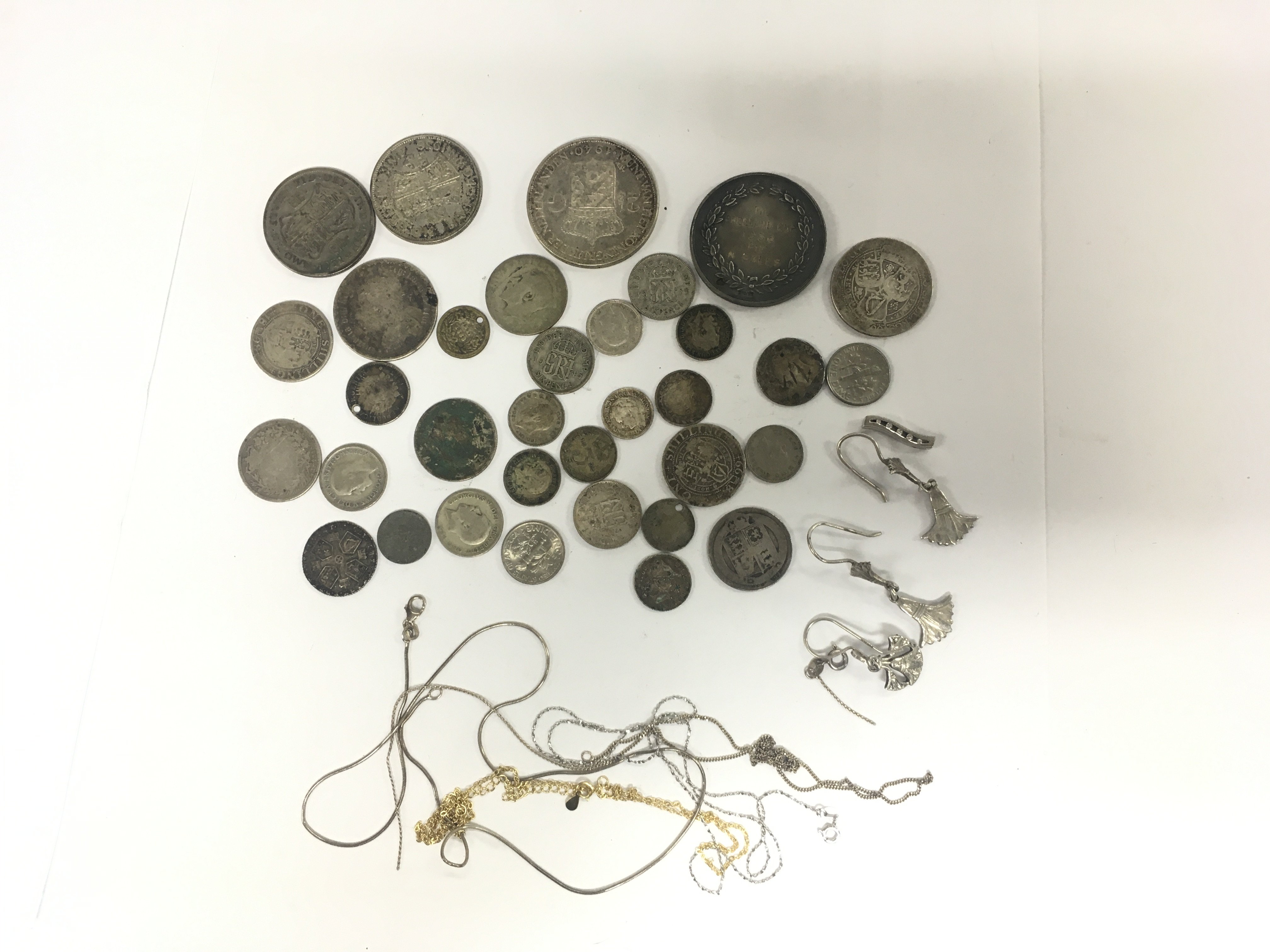 A collection of silver coins and chains, total approx weight 195g. Shipping category A.