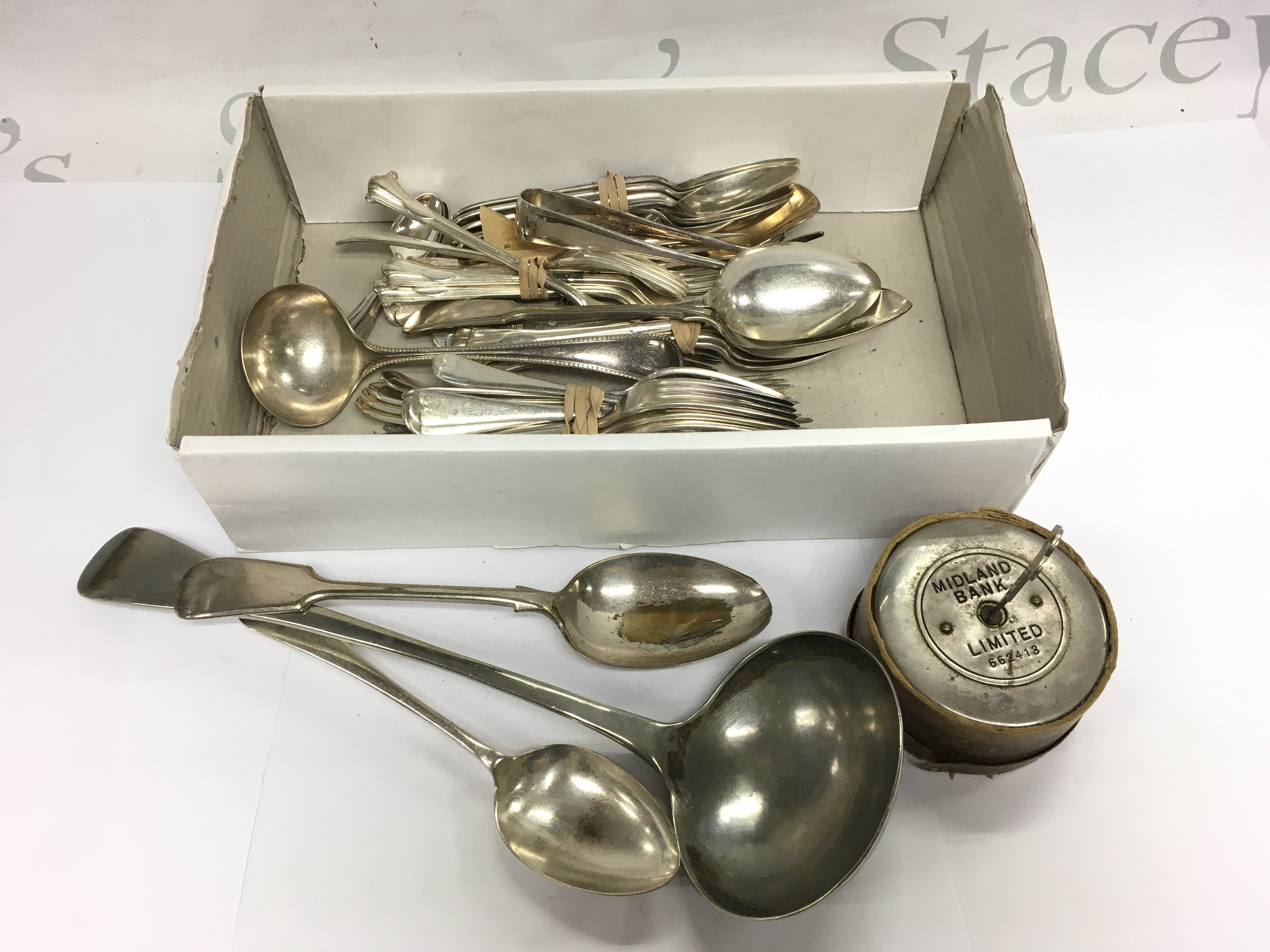 A box of silver plated cutlery and a metal lock and key marked Midland Bank. Shipping category D.