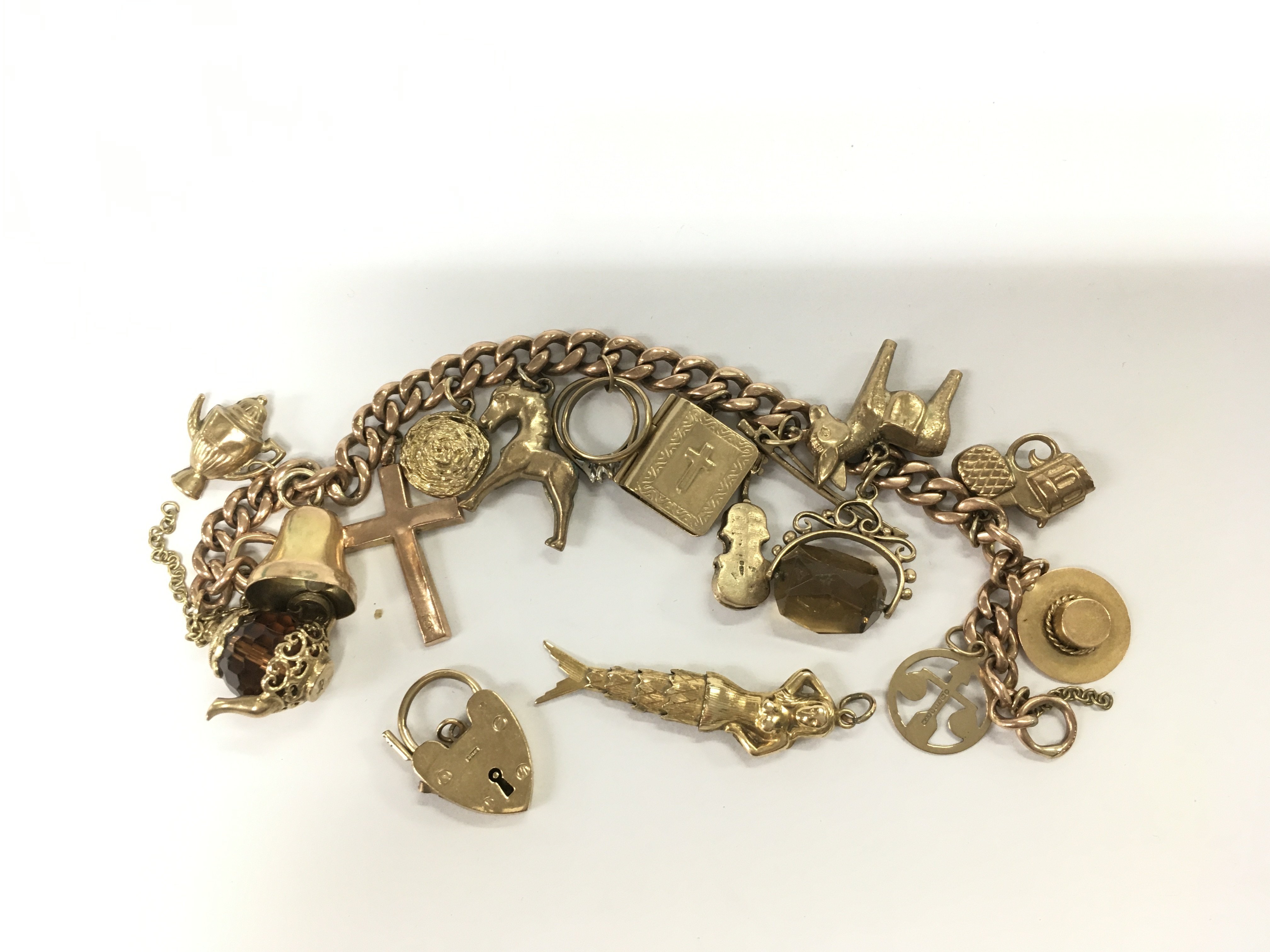A 9ct gold charm bracelet, approx 44.8g. Shipping category A.
