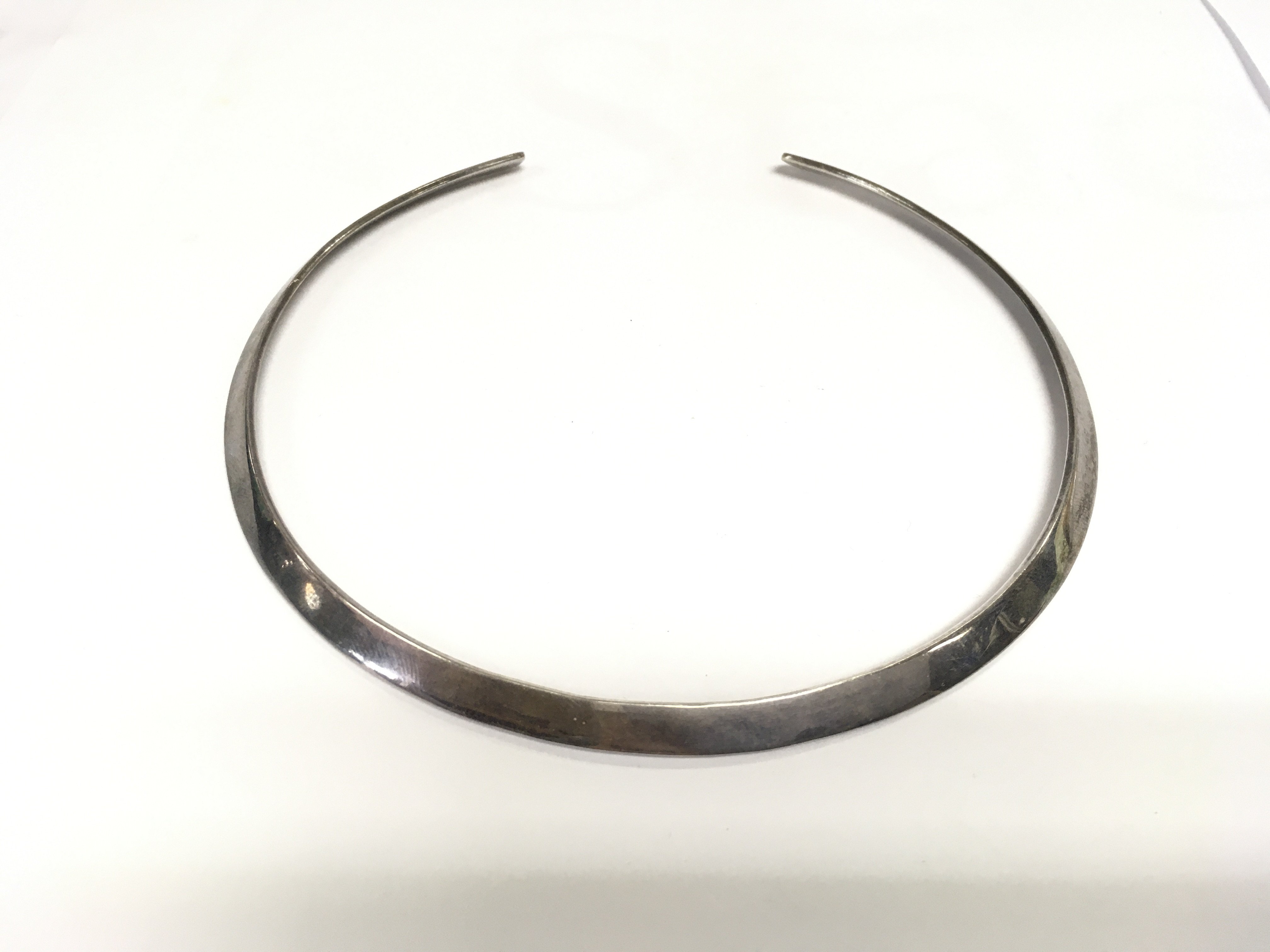 A silver necklace. Shipping category A.