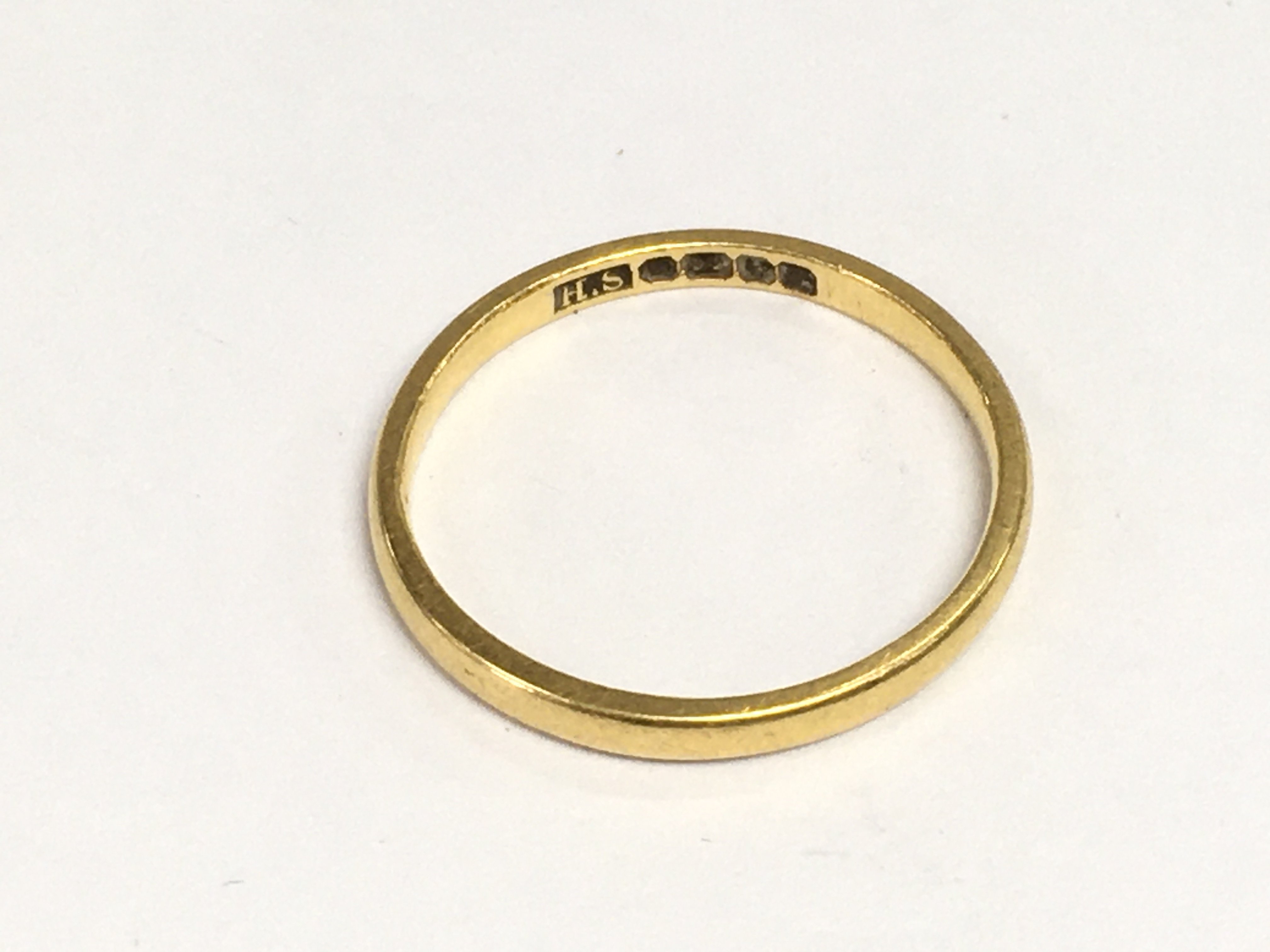 A 22ct gold wedding band, approx 2g and approx size L-M. Shipping category A.