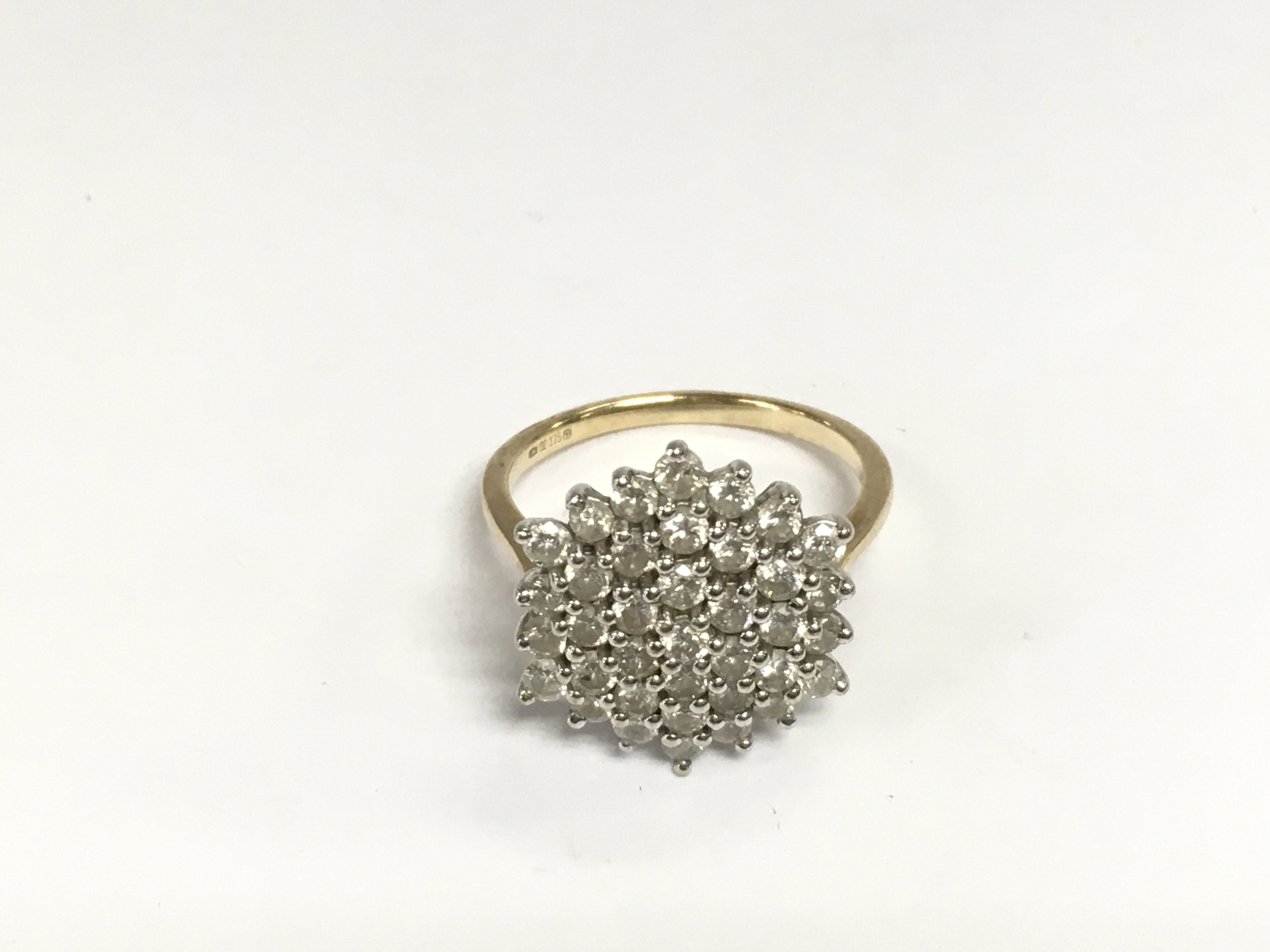 A 9ct gold diamond cluster ring, approx 4.8g and approx size Q-R. Shipping category A.