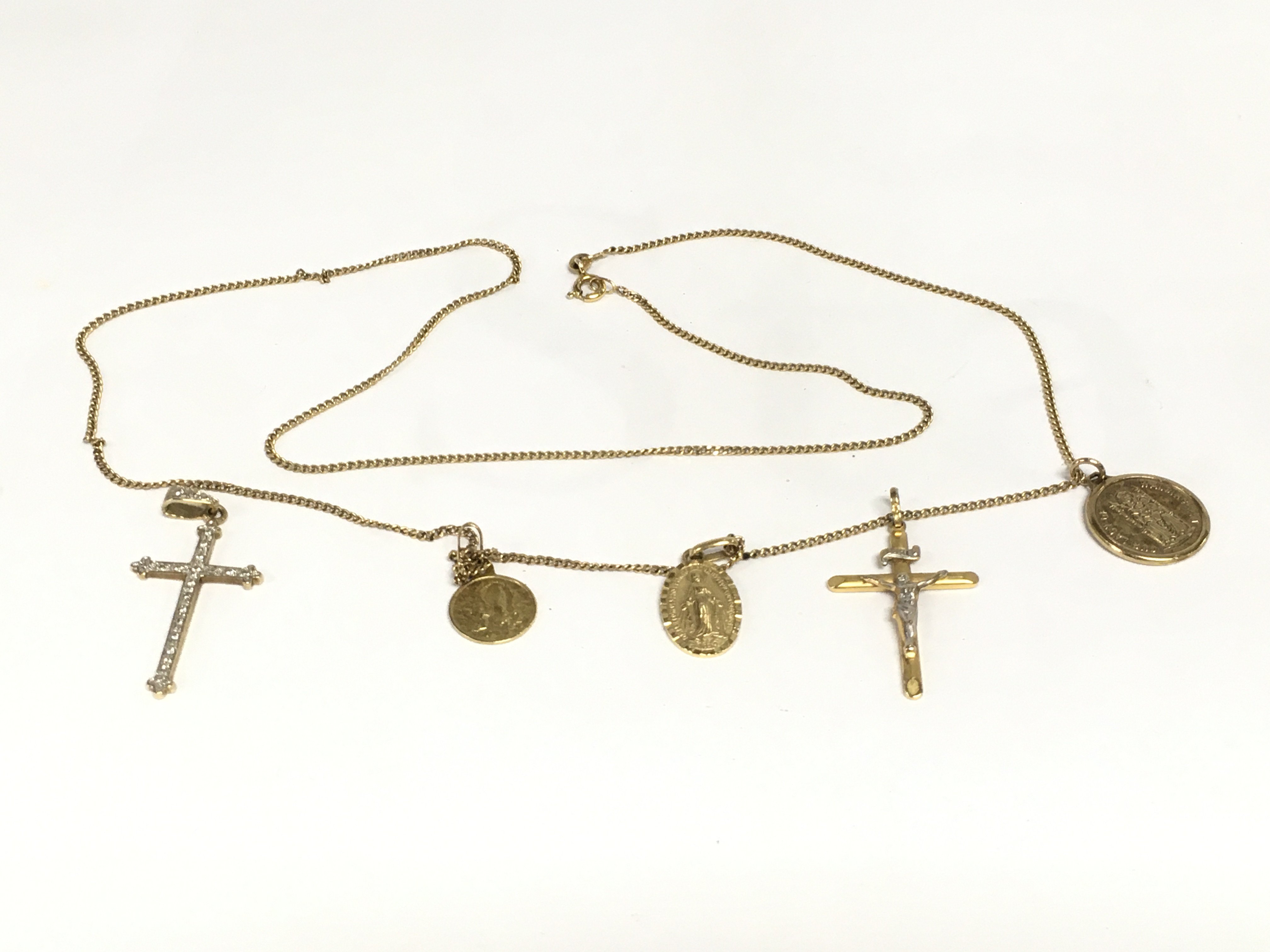 A 9ct gold necklace we attached crosses and religious pendants, approx 10.5g. Shipping category A.